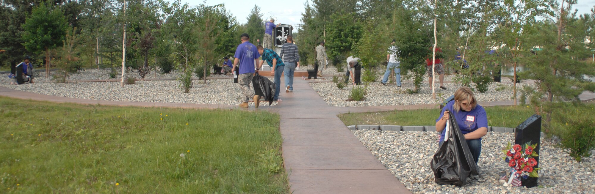 Military members from Eielson Air Force Base and Fort Wainwright Alaska along with civilians from the local community remove trash, clean memorials and perfom other various tasks to beautify Fort Wainwright's Memorial Park July 10, 2009. Community Partnership Day was first held in 2001 and aims to bring Airmen, Soldiers and civilians together while doing a community service project.
