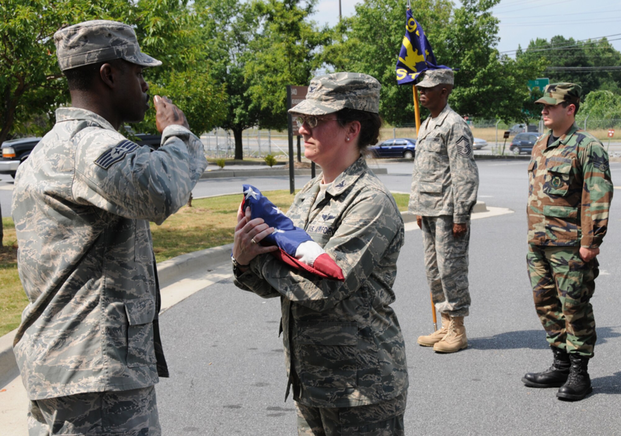 Staff Sgt. Phillip E. Corry, 94th Aeromedical Staging Squadron, salutes the flag as it is presented to Col. Susan E. Northup, 94th ASTS commander, during a retreat ceremony at Dobbins Air Reserve Base July 11. (U.S. Air Force Photo/Tech. Sgt. Nicholas Ontiveros)