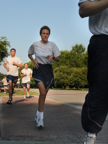 Airmen participating in the Commander's 5K Run/Walk Challenge spread out as they cross East Jackson Drive here July 10. Participants of the fitness challenge ran or walked a 5K course along Hill Boulevard, Bates Street, Davis Drive, James Avenue and Jackson Drive. (U.S. Air Force photo/Staff Sgt. Daniel Bowles)