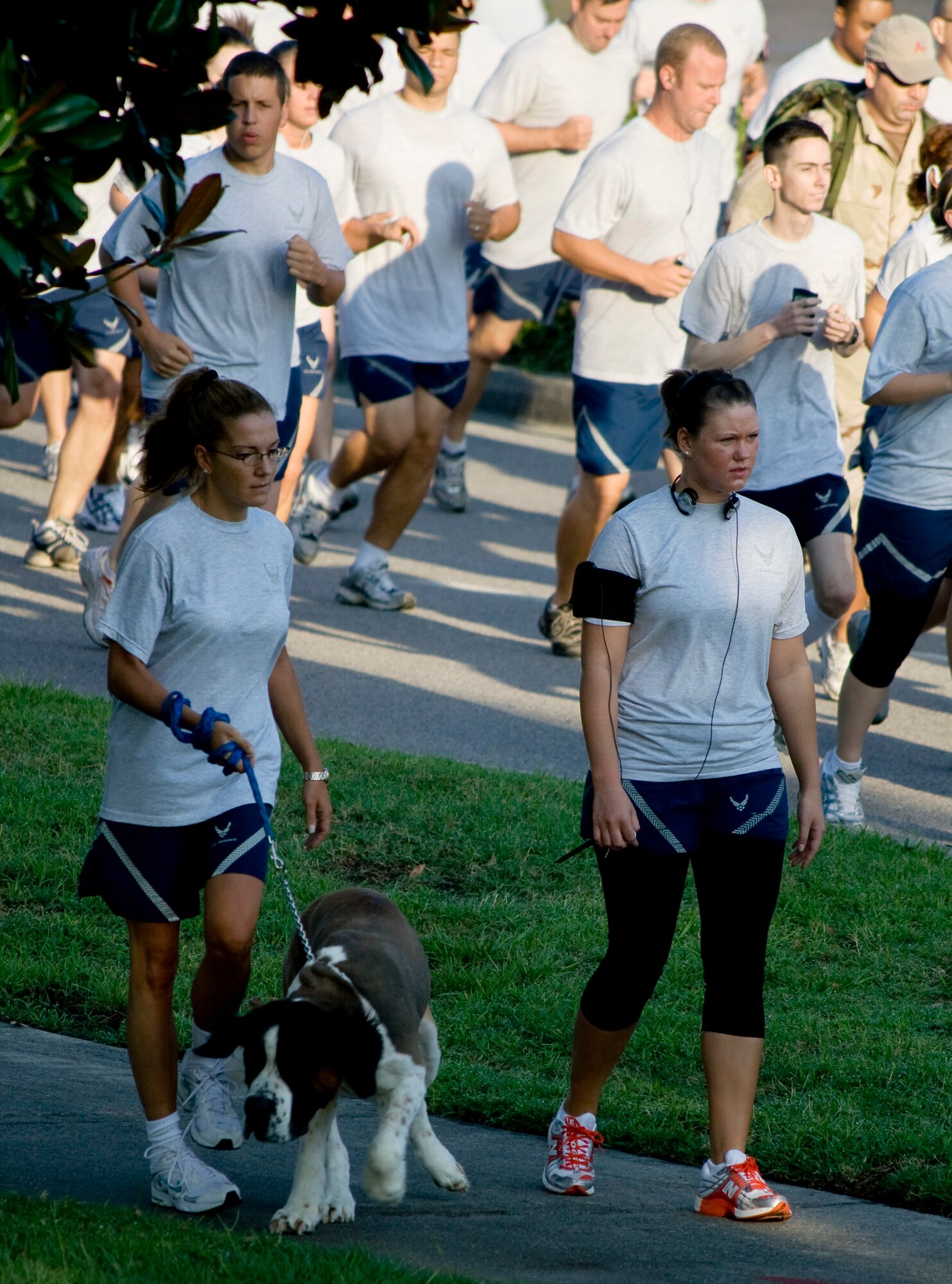 Airmen walk along Hill Boulevard at the start of the Commander's 5K Run/Walk Challenge here July 10. Airmen from various squadrons across Charleston AFB participated in the fitness challenge, some bringing along their children and pets to enjoy the event. (U.S. Air Force photo/Laurie Ladd)