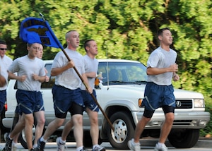 Airmen with the 437th Communications Squadron pace themselves beside vehicles traveling at reduced speeds along Hill Boulevard during the Commander's 5K Run/Walk Challenge here July 10. (U.S. Air Force photo/Staff Sgt. Daniel Bowles)