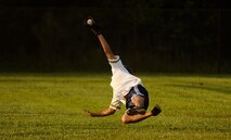 Jeremy Lock of the 1st Combat Camera Squadron makes a diving catch during a softball game against the Aerial Port Squadron July 14. 1CTCS dominated the field Tuesday night as they played a double header against the 437th Aerial Port Squadron they won 10-7 and against the 437th Force Support Squadron they won 10-2. Lock is a combat photographer in the 1 CTCS. (U.S. Air Force photo/ Senior Airman Nicholas Pilch)