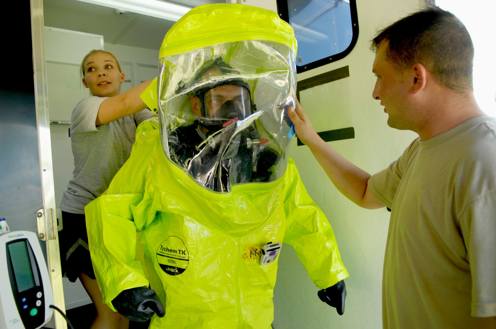 SHAW AFB, S.C. -- Staff Sgt. Susanne Smith, 20th Aerospace Medical Squadron bioenvironmental section, helps Tech. Sgt. Jody Brown, also of the 20th AMDS, into a Level A  suit during the Air Combat Command Chemical, Biological, Radiological and Nuclear Challenge, July 15. Level A suits are fully encapsulating personal protective equipment complete with a self-contained breathing apparatus. In real world incidents, Level A suits are donned when emergency responders deal with an unknown variable. (U.S. Air Force photo/Senior Airman Kathrine McDowell)
