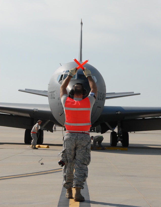 Master Sgt. Michael Chandler marshals a KC-135 returning to Forbes Field from the Operational Readiness Inspection at Alpena, Michigan. (photo by Master Sgt. Allen Pickert)
