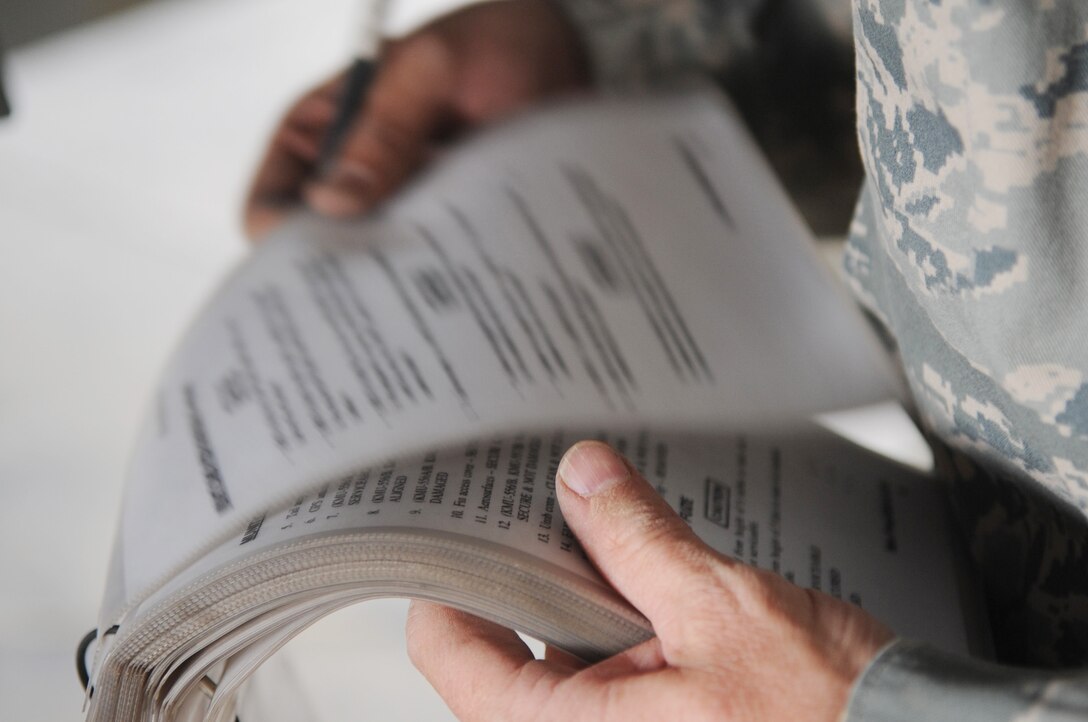 Tech. Sgt. Brett Kitzman reviews a checklist before loading munitions onto an F-16 Fighting Falcon June 29 at Joint Base Balad, Iraq. Sergeant Kitzman is a 332nd Expeditionary Aircraft Maintenance Squadron weapons loader. He is deployed from Buckley Air Force Base, Colo., and is a native of Aurora, Colo. (U.S. Air Force photo/Senior Airman Elizabeth Rissmiller) 