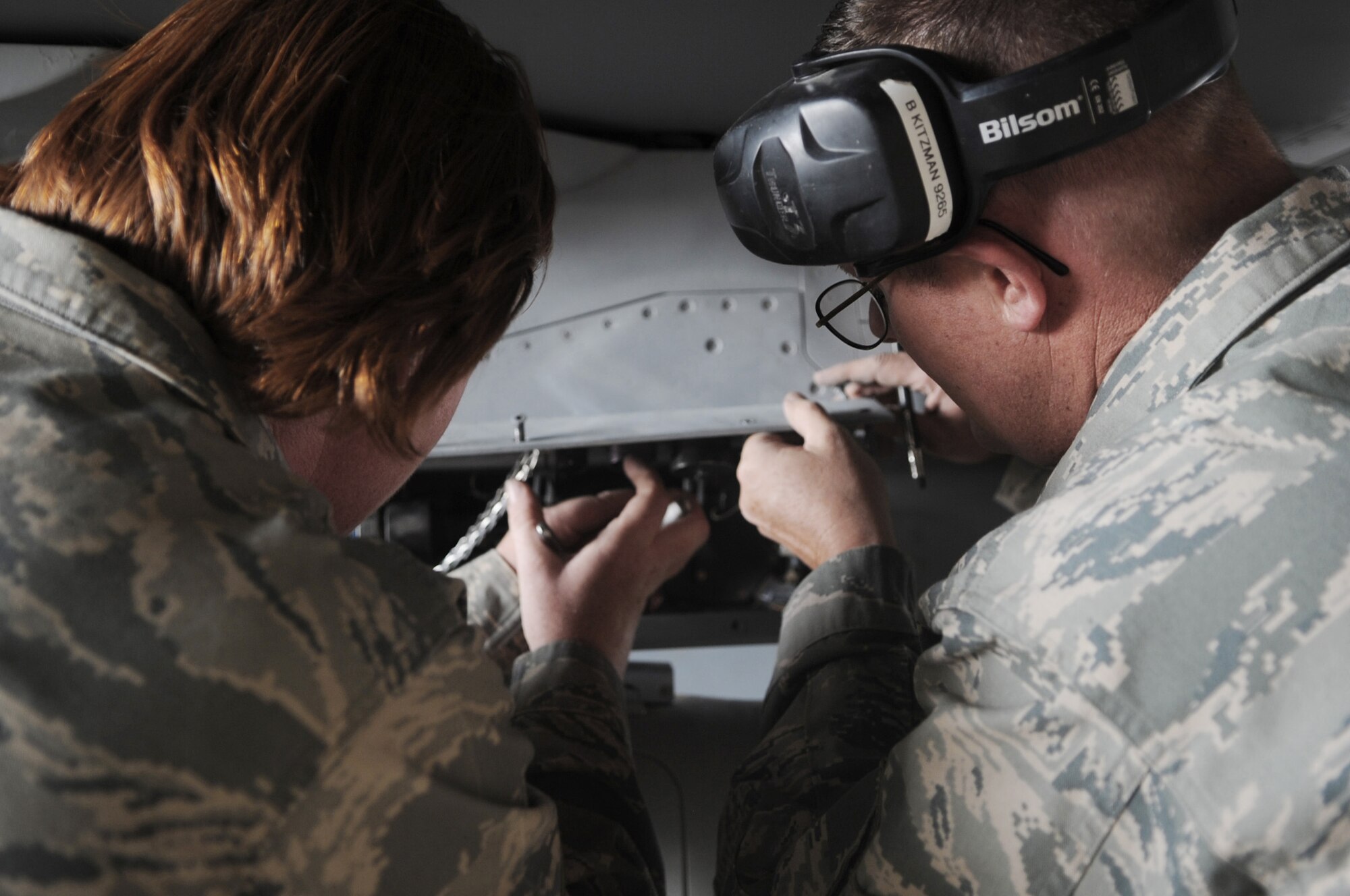 Staff Sgt. Michelle Torrey and Tech. Sgt. Brett Kitzman check connections after loading munitions onto an F-16 Fighting Falcon June 29 at Joint Base Balad, Iraq. Sergeants Torrey and Kitzman are 332nd Expeditionary Aircraft Maintenance Squadron weapons loaders and deployed from Buckley Air Force Base, Colo. Sergeant Torrey is a native of Greeley, Colo., and Sergeant Kitzman is from Aurora, Colo. (U.S. Air Force photo/Senior Airman Elizabeth Rissmiller) 