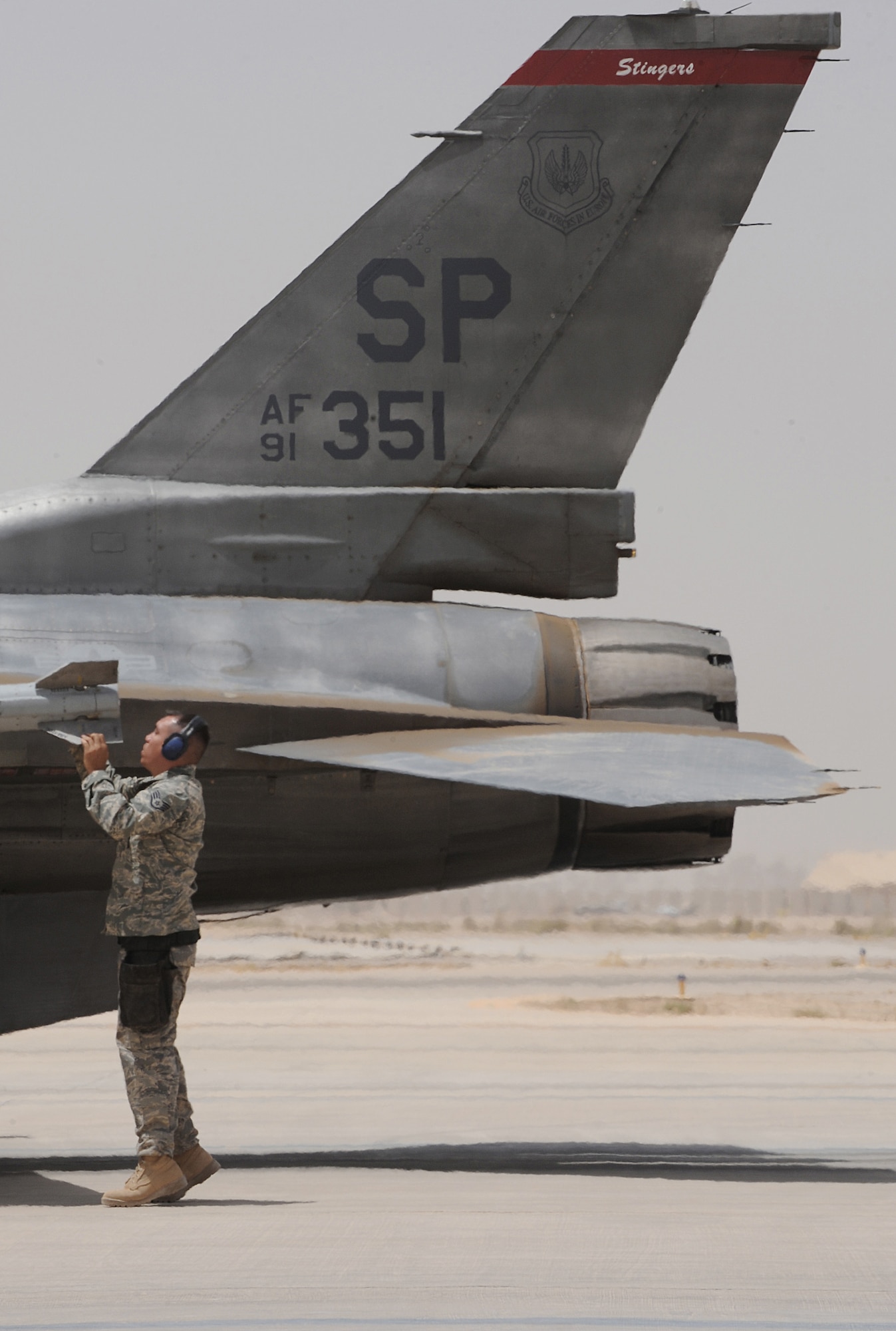 Staff Sgt. David Yocom makes a final check and pulls the safety pins from weapons loaded onto an F-16 Fighting Falcon before takeoff June 29 at Joint Base Balad, Iraq. Sergeant Yocom is a 332nd Expeditionary Aircraft Maintenance Squadron weapon load crew chief. He is deployed from Spangdahlem Air Base, Germany, and is a native of Oldbridge, N.J. (U.S. Air Force photo/Senior Airman Elizabeth Rissmiller) 
