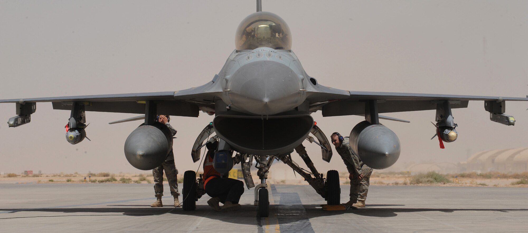 Airmen from the 332nd Expeditionary Aircraft Maintenance Squadron make final checks to weapons loaded onto an F-16 Fighting Falcon before takeoff June 29 at Joint Base Balad, Iraq. (U.S. Air Force photo/Senior Airman Elizabeth Rissmiller) 

