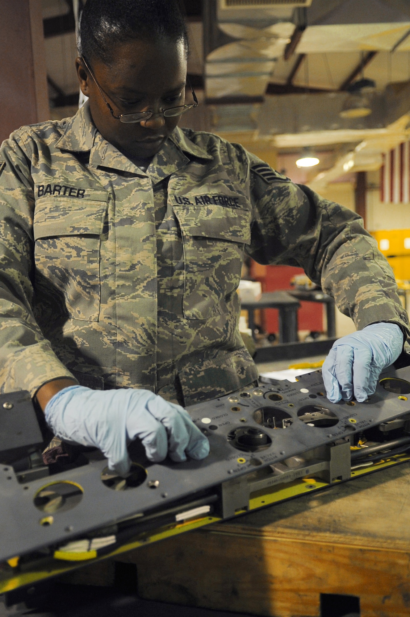 Staff Sgt. Kusan Barter inspects a piece of weapons release equipment for an F-16 Fighting Falcon June 29 at Joint Base Balad, Iraq. Sergeant Barter is a 332nd Expeditionary Aircraft Maintenance Squadron armament-systems craftsman, deployed from Spangdahlem Air Base, Germany, and is a native of Pensacola, Fla. (U.S. Air Force photo/Senior Airman Elizabeth Rissmiller)