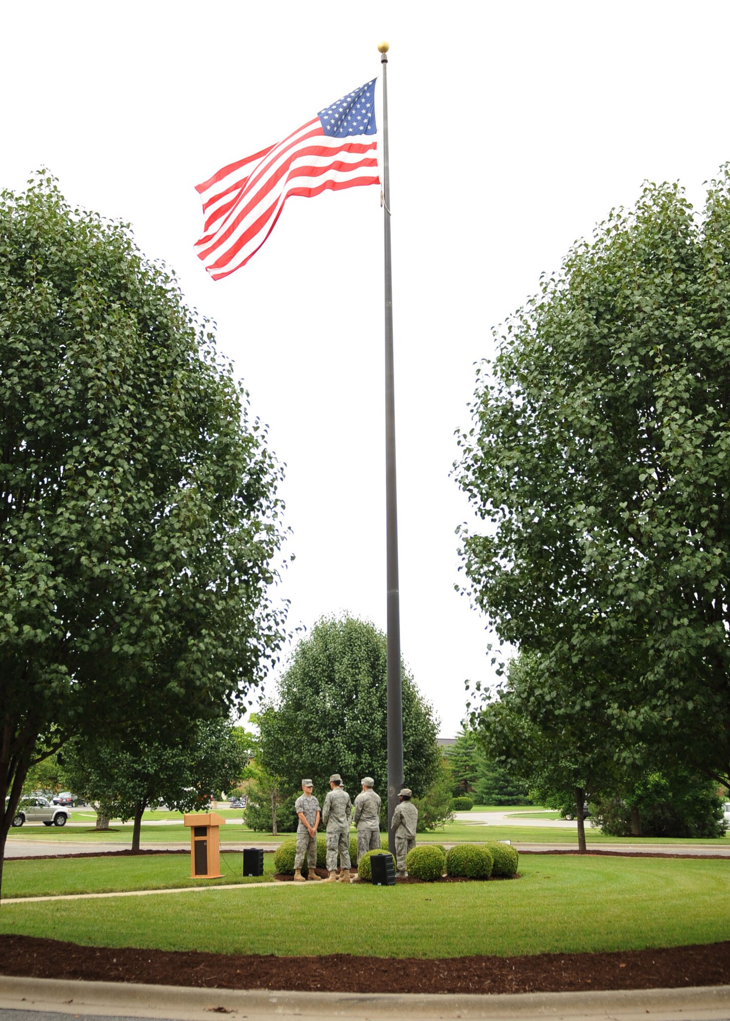 SCOTT AIR FORCE BASE -- Airmen from the Air Force Communications Agency lower the U.S. flag outside of AFCA headquarters during a final retreat ceremony July 14. The retreat was the last one under the AFCA name, AFCA was re-designated as the Air Force Network Integration Center July 15. (U.S. Air Force photo/ Airman 1st Class Wesley Farnsworth)