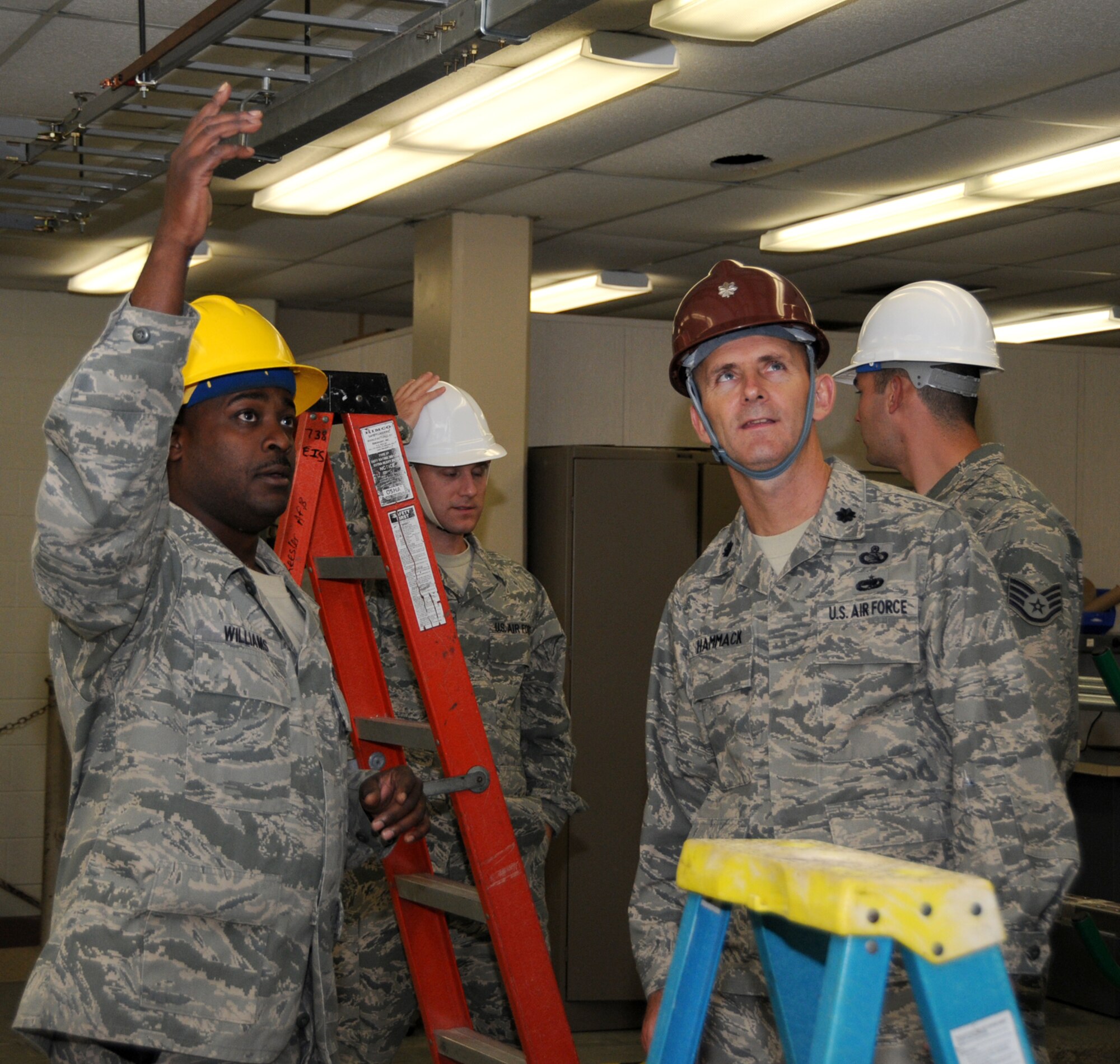 Tech. Sgt. Bennie Williams, instructor for the 85th Engineering Installation Squadron’s electronics standard installation practices course, briefs the squadron’s new commander, Lt. Col. Lonnie Hammack.  Colonel Hammack, who assumed command July 9 from Lt. Col. Tracy Jackson, was previously chief of C4 plans and exercises at U.S. Pacific Command headquarters, Camp Smith, Hawaii. Colonel Jackson is now assigned to the Defense Information Systems Agency, Washington.  (U.S. Air Force photo by Kemberly Groue)