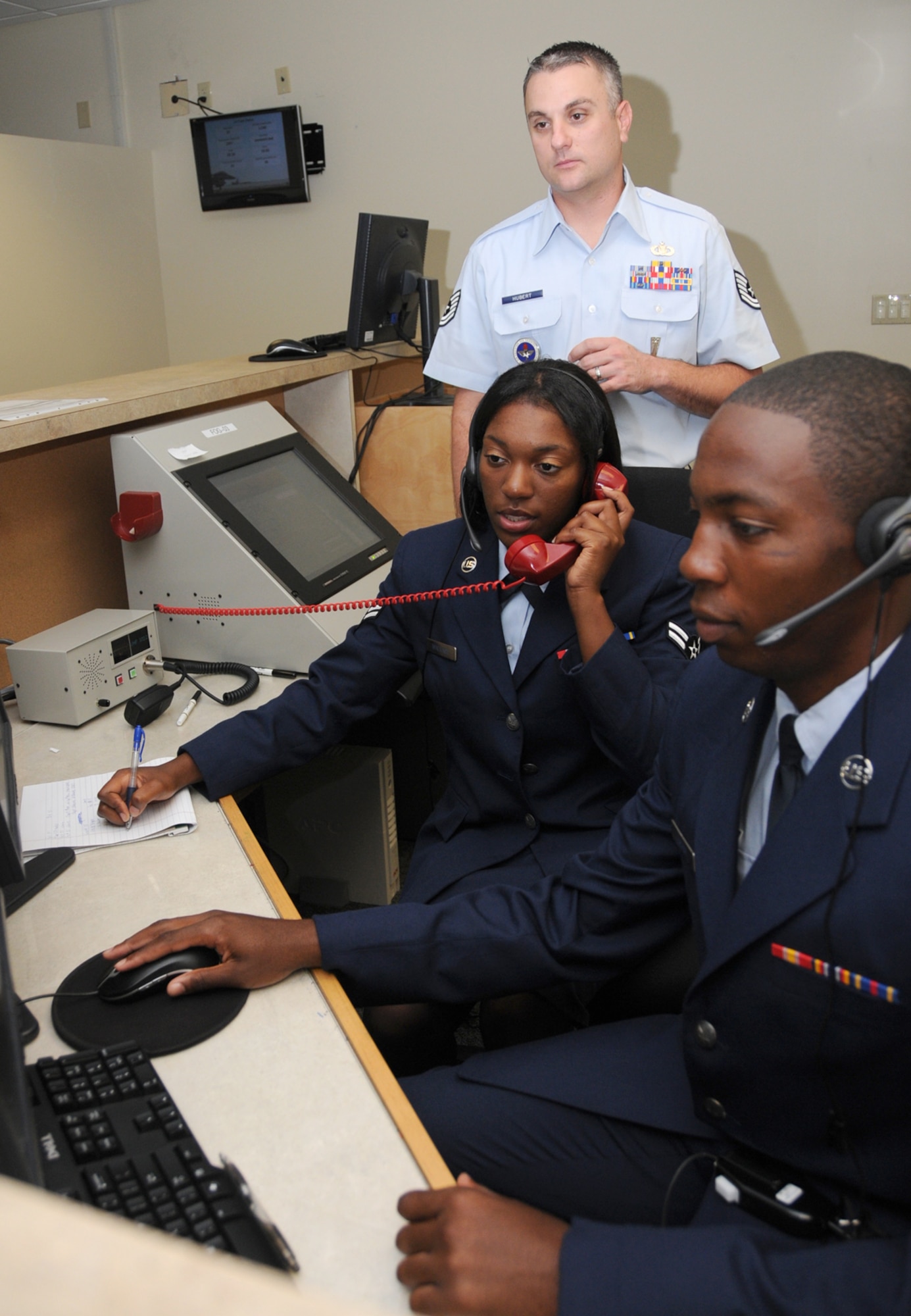 Sergeant Hubert, standing, trains Airman Wallace and Airman Basic DeAnte Lever on squadron host aviation resource management laboratory equipment.  (U.S. Air Force photo by Kemberly Groue)