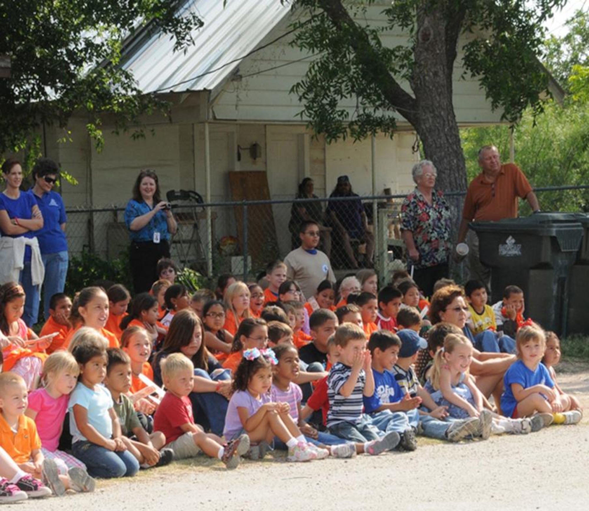 Residents of Eden, Texas watch as a suspected drug house is demolished.