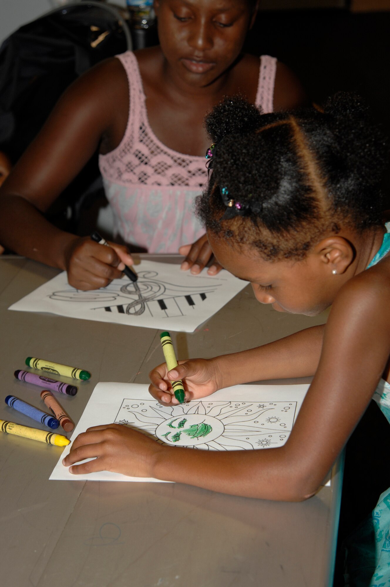 MCCONNELL AIR FORCE BASE, Kan. -- Jahnie Kruzelnick, 4, daughter of Kareen and Master Sgt. Brian Kruzelnick, 22nd Aircraft Maintenance Squadron, colors a picture during pre-school story time at the Robert J. Dole Community Center, July 14. The story time includes arts and crafts and is sponsored by the base library. (Photo by Senior Airman Laura Suttles)