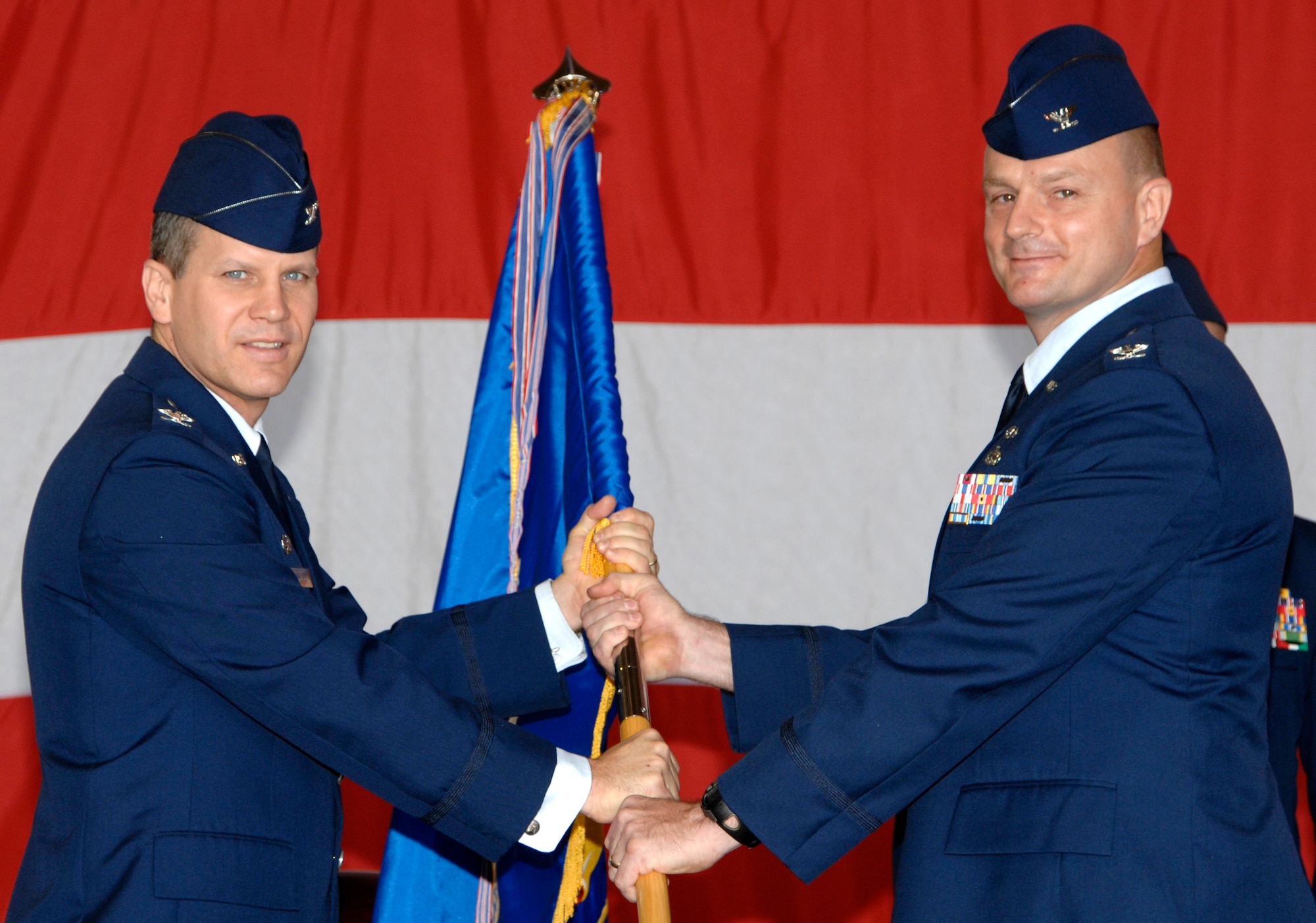 MCCONNELL AIR FORCE BASE, Kan. -- Col. Jamie W. Crowhurst, 22nd Air Refueling Wing commander, receives the guidon from Col. Allan Day, 22nd Maintenance Group commander, during the 22nd MXG change of command ceremony in hangar 1176, July 9. Colonel Day recently arrived from Maxwell Air Force Base, Ala. (Photo by Senior Airman Laura Suttles)