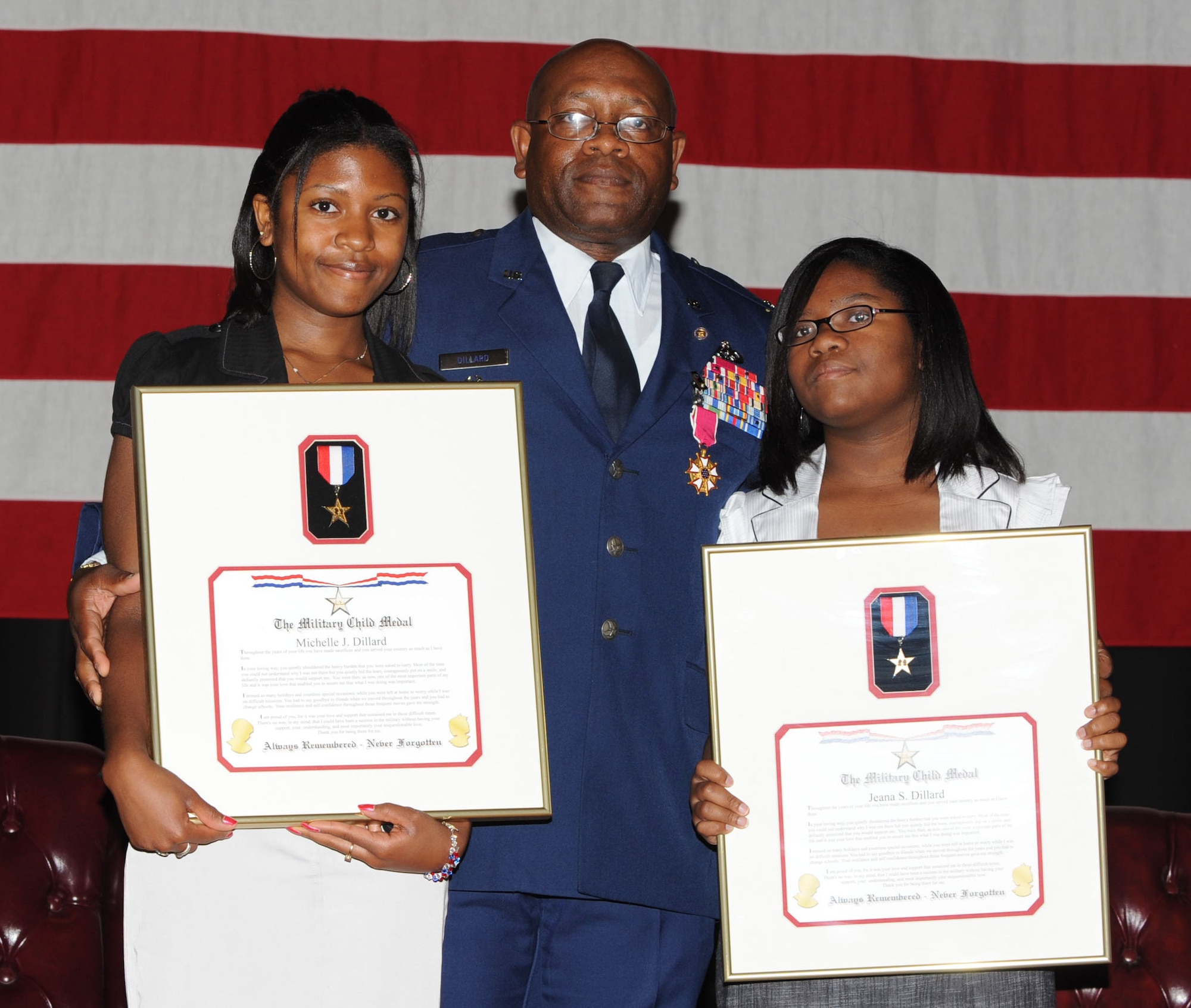 MCCONNELL AIR FORCE BASE, Kan. -- Col. Michael Dillard, former Maintenance Group commander, poses with his daughters, Michelle, 18, and Jeana, 12, after giving them the military child medal during his retirement ceremony.  (Photo by Tech. Sgt. Chyrece Campbell)