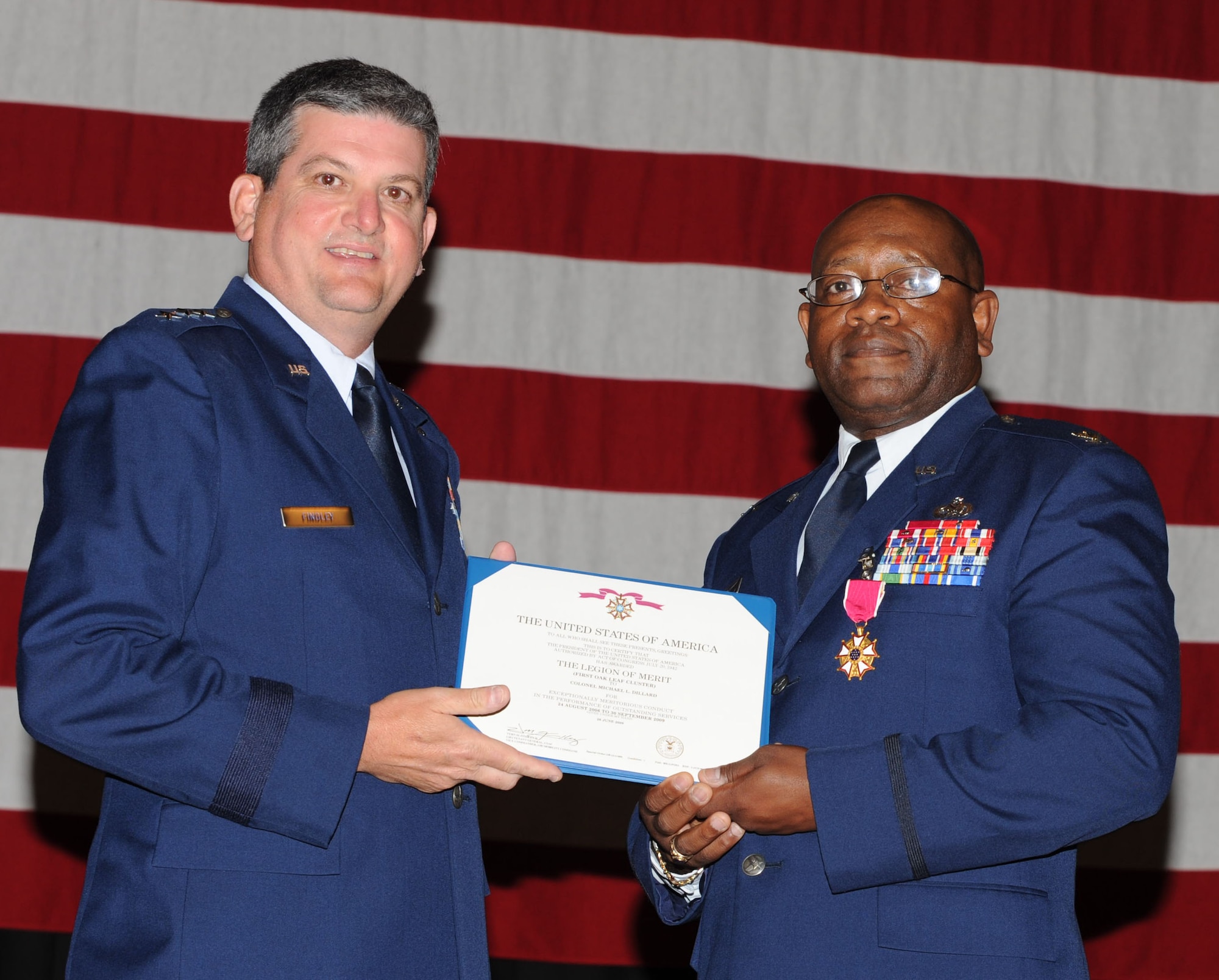 MCCONNELL AIR FORCE BASE, Kan. -- Lt. Gen. Rusty Findley, Air Mobility Command vice commander, presents Col. Michael Dillard, former Maintenance Group commander, with the Legion of Merit.  General Findley was the presiding officer for Colonel Dillard’s retirement. (Photo by Tech. Sgt. Chyrece Campbell)