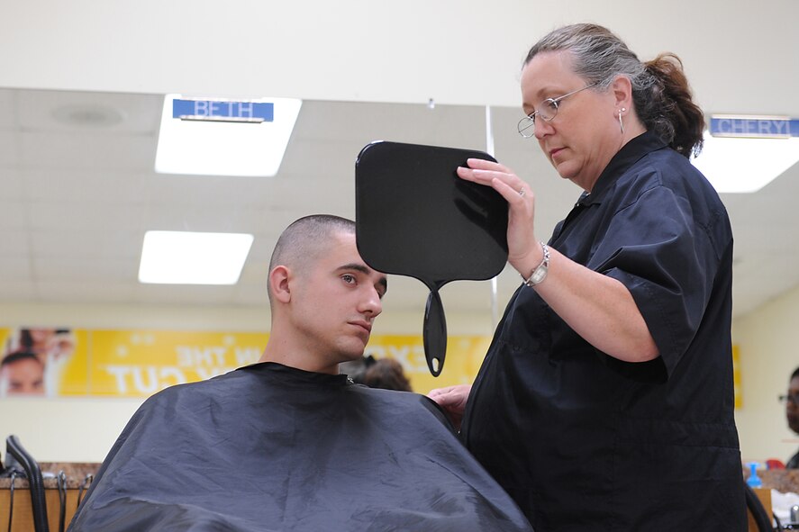 Beth Dawley, Army & Air Force Exchange Service barber, gets approval from Kevin Pierce after his haircut at the Base Exchange barber shop on Seymour Johnson Air Force Base, N.C., July 10, 2009. Mrs. Dawley has cut the hair of servicemembers, dependents and retirees for 17 years. (U.S. Air Force photo by Airman 1st Class Whitney S. Lambert)