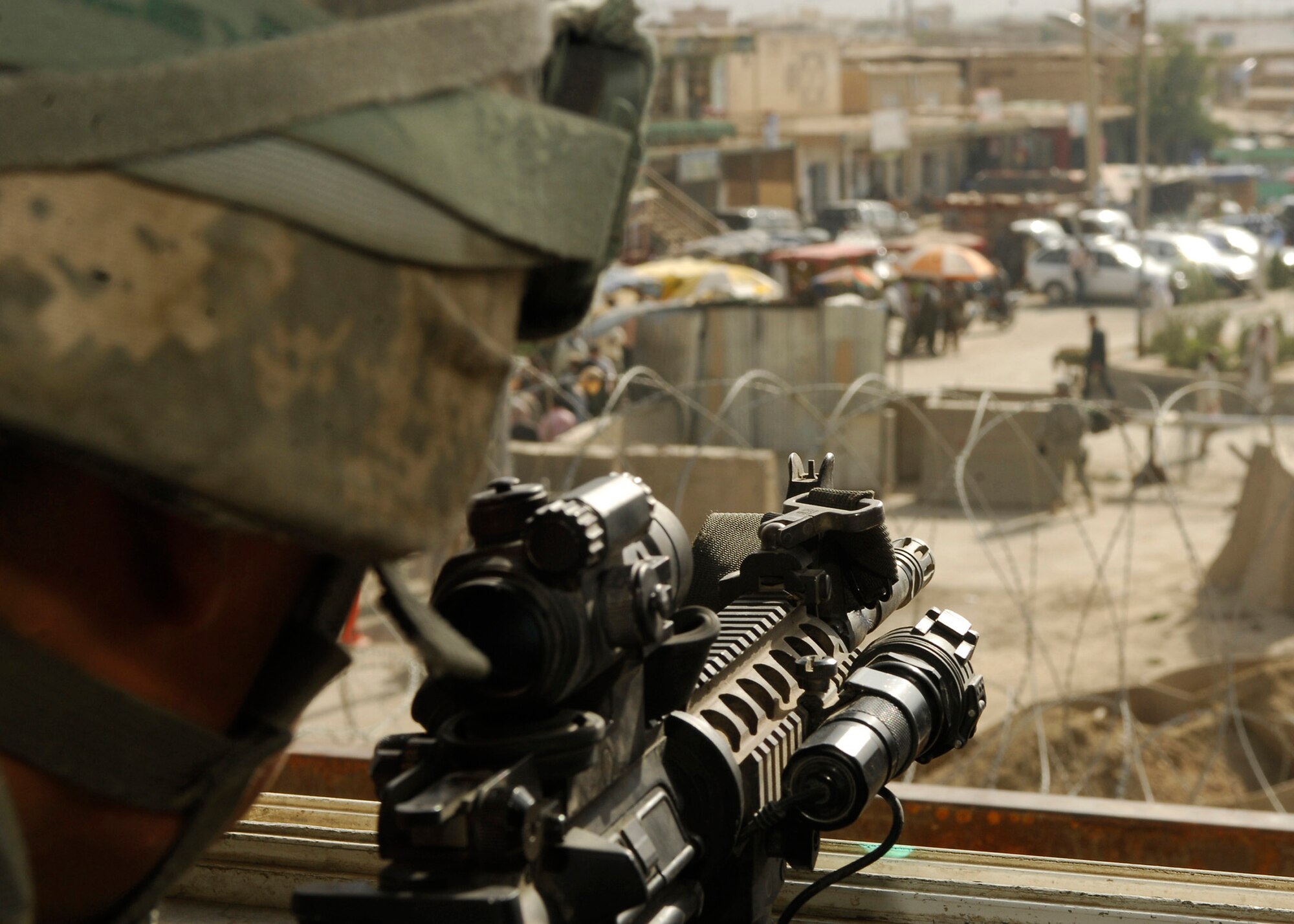 Staff Sgt. Steven Lugo-Velez can see much of the town from his overwatch tower surrounding Bagram Airfield, Afghanistan. Sergeant Lugo-Velez is in the 455th Expeditionary Security Forces Squadron, originally from New York City, and is currently stationed at Edwards Air Force Base, Calif.(U.S. Air Force photo/Senior Airman Susan Tracy) 