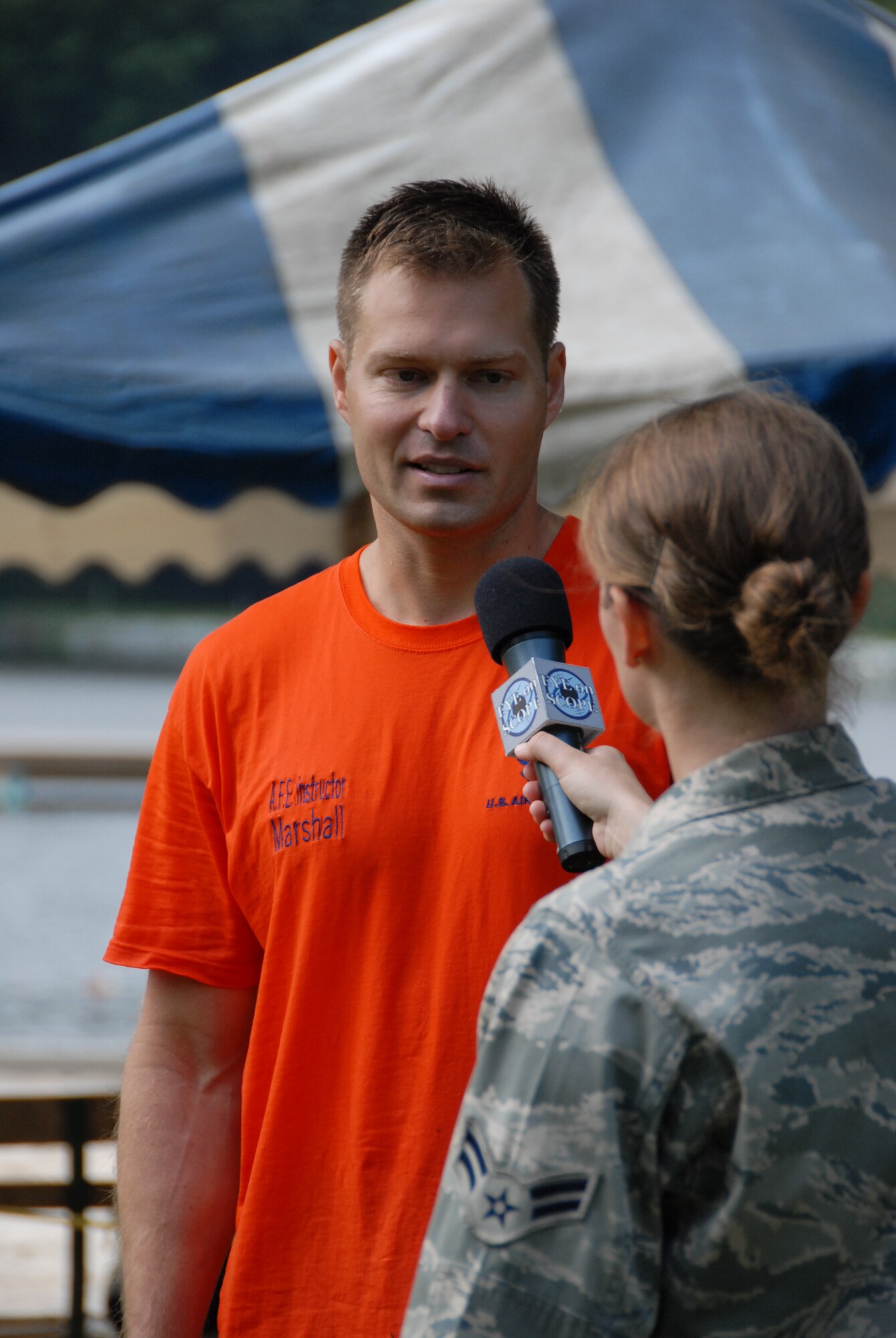 Airman 1st Class Claire Behney, a public affairs journalist, interviews Senior Master Sgt. Matt Marshall about the water survival training he was conducting at Mount Gretna Lake, Pa., for flight crew members of the 193rd Special Operations Wing located in Middletown, Pa. Marshall is the aircrew flight equipment superintendent at the 193rd SOW.