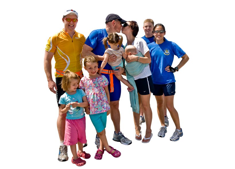 True Grit - With support from family, friends and teammates, Turnipseed and his team finished second in the extreme category of the race. Pictured, Turnipseed kisses his wife, Tricia, while their four children were also there to greet their father and his Big Cats 
teammates at the finish line. (photo by Tech. Sgt. Matthew Hannen-Digital composite by David M. Stac)