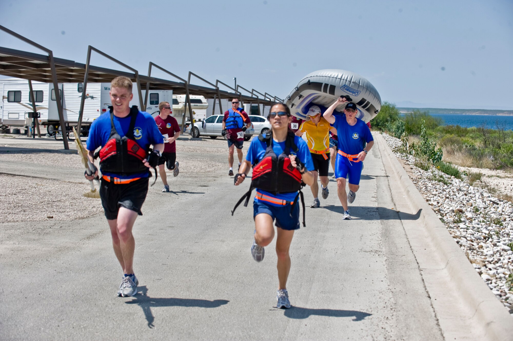 True Grit - Big Cats teammates, from left to right, Capt. Mike Lashinshki and 1st Lt. Stella Glojek lead the way as Turnipseed and Lt. Col. Todd Craigie carry the raft to the finish line. All are T-6 Texan II pilots at Laughlin AFB, Texas. (photo by Tech. Sgt. Matthew Hannen)