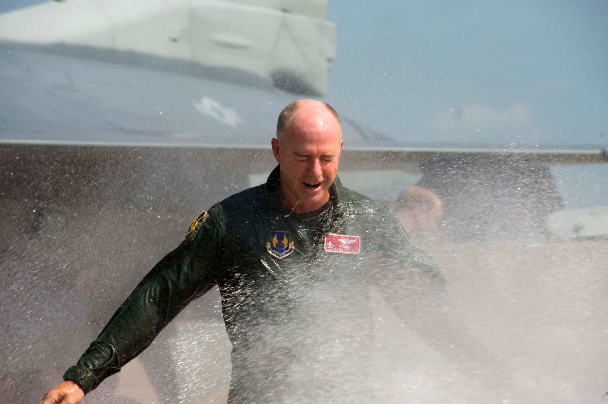 Col. Gary Plumb, 46th Test Wing commander, returns to a wet reception from his final flight in an F-16, July 14.  He will retire July 20 after serving more than 27 years in the Air Force.  Colonel Plumb has commanded the 46th TW for more than two years. (U.S. Air Force Photo/Bruce Hoffman)