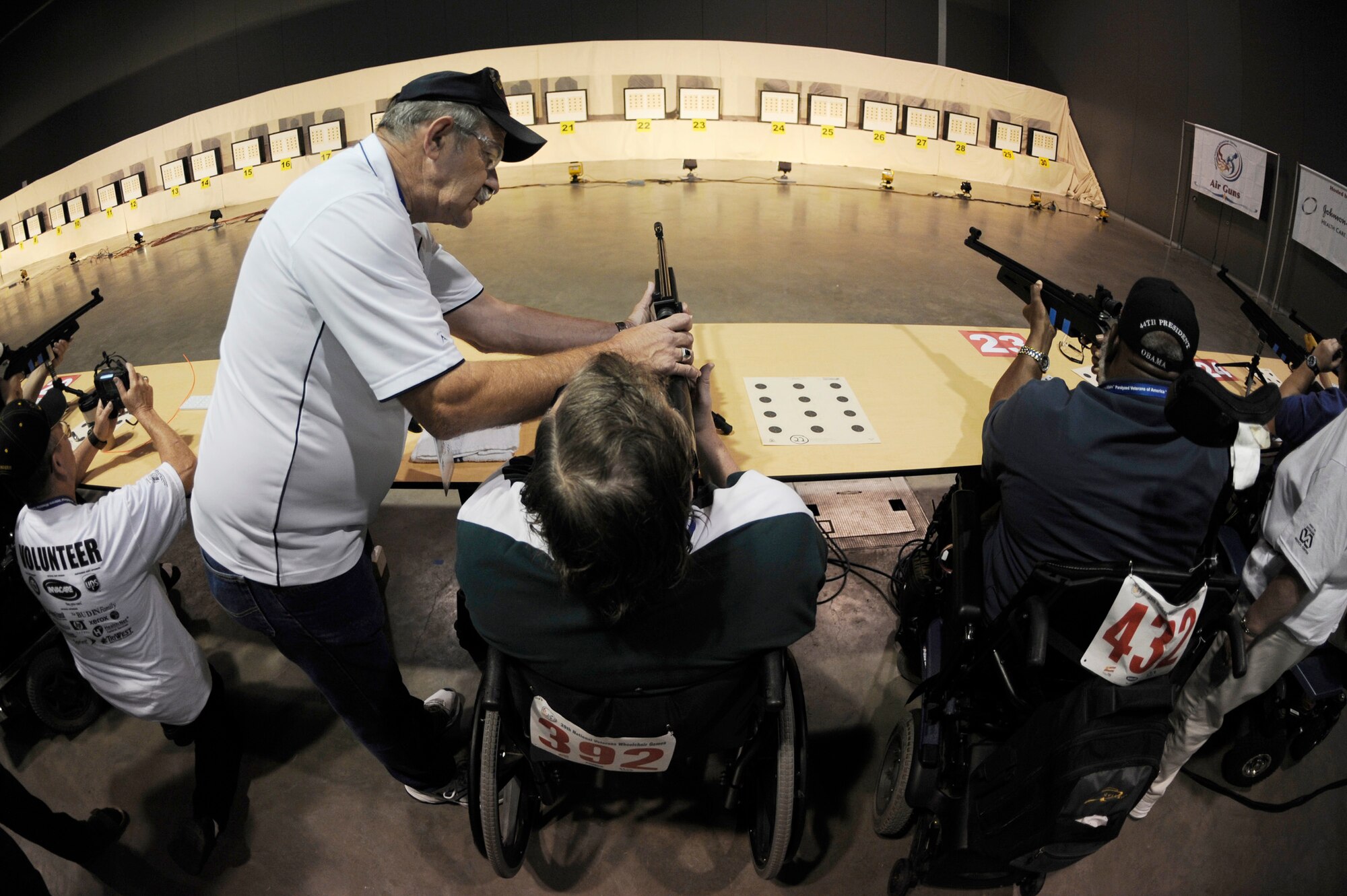 William Ethridge gets assistance from a volunteer as he competes in the air gun competition during the 29th National Veterans Wheelchair Games July 14 in Spokane, Wash. Mr. Ethridge is an Air Force veteran and resides in Spokane. The 29th National Veterans Wheelchair Games runs through July 19. (U.S. Air Force photo/Staff Sgt. Desiree N. Palacios)