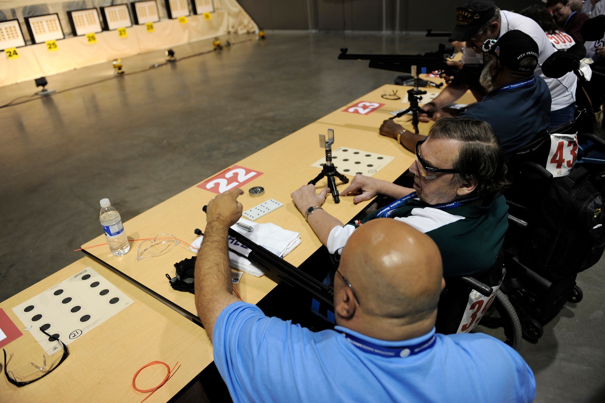 William Ethridge gets assistance from a volunteer as he competes in the air gun competition during the 29th National Veterans Wheelchair Games July 14 in Spokane, Wash. Mr. Ethridge is an Air Force veteran and resides in Spokane. The 29th National Veterans Wheelchair Games runs through July 19. (U.S. Air Force photo/Staff Sgt. Desiree N. Palacios) 