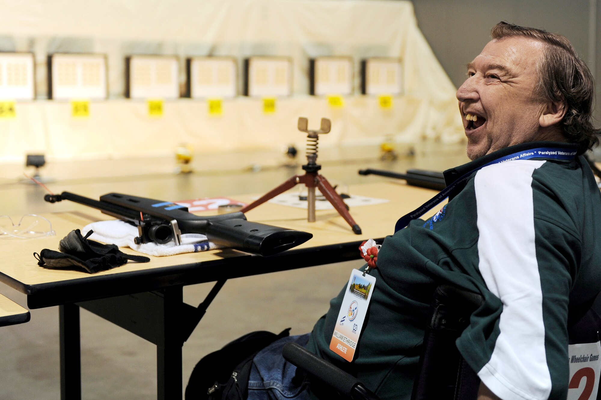 William Ethridge smiles as he competes in the air gun competition during the 29th National Veterans Wheelchair Games July 14 in Spokane, Wash. Mr. Ethridge is an Air Force veteran and resides in Spokane. The 29th National Veterans Wheelchair Games runs through July 19. (U.S. Air Force photo/Staff Sgt. Desiree N. Palacios) 