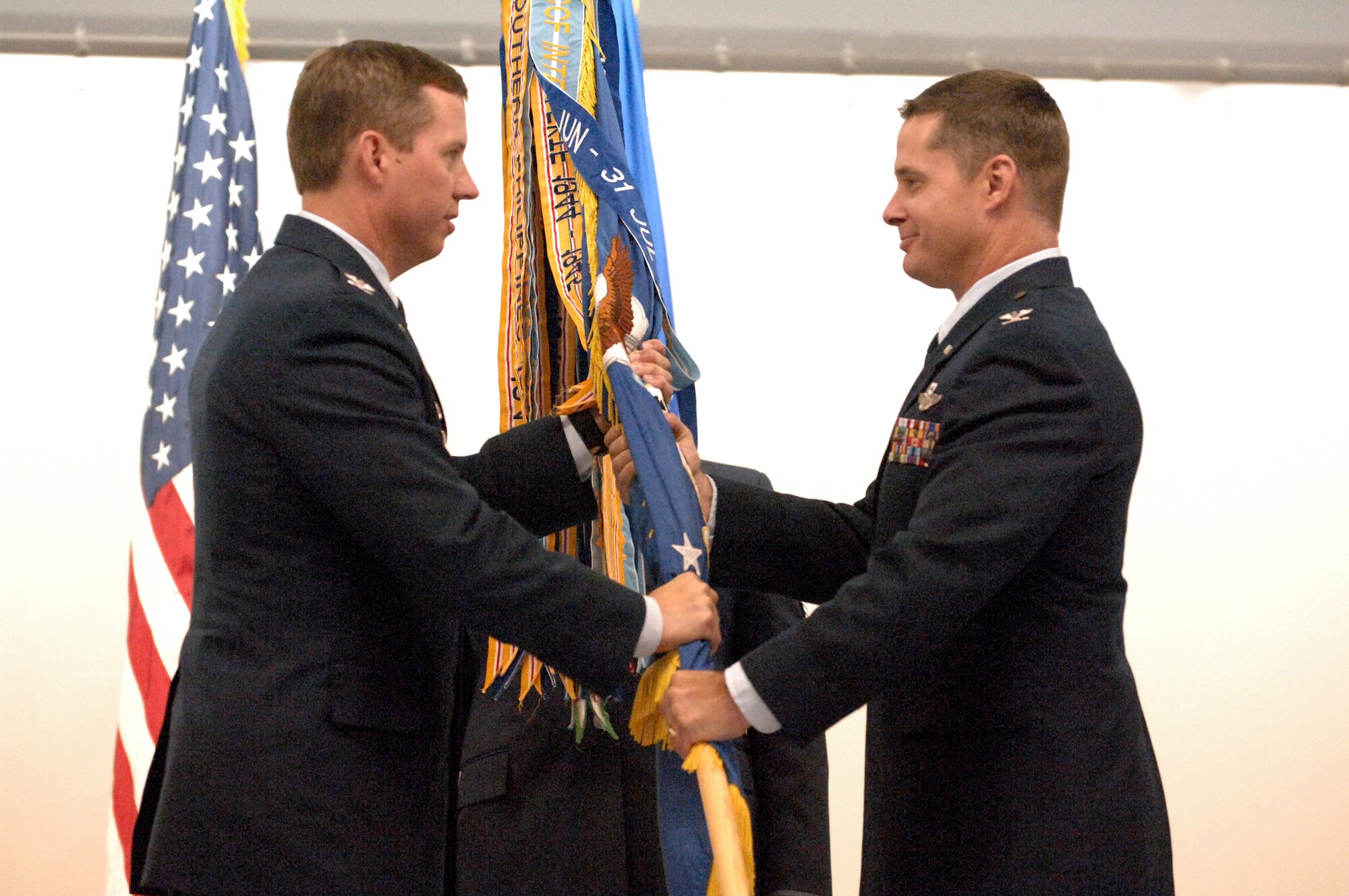 ELMENDORF AIR FORCE BASE, Alaska -- Col. Thomas Bergeson passes the 3rd Operations Group flag into the hands of the new commander, Col. William Routt during the 3rd OG change of command ceremony July 10. Bergeson is the 3rd Wing commander. (U.S. Air Force photo/Tech. Sgt. Brian Smith)