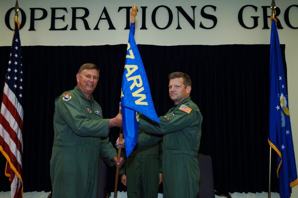 Lt. Col Paul Gates (right) assumes command of the 63rd Air Refueling Squadron at the Assumption of Command Ceremony July 11, 2009.  Col Doug Schwartz, (left) 927th Air Refuleing Wing Operations Group Commander passes the flag.