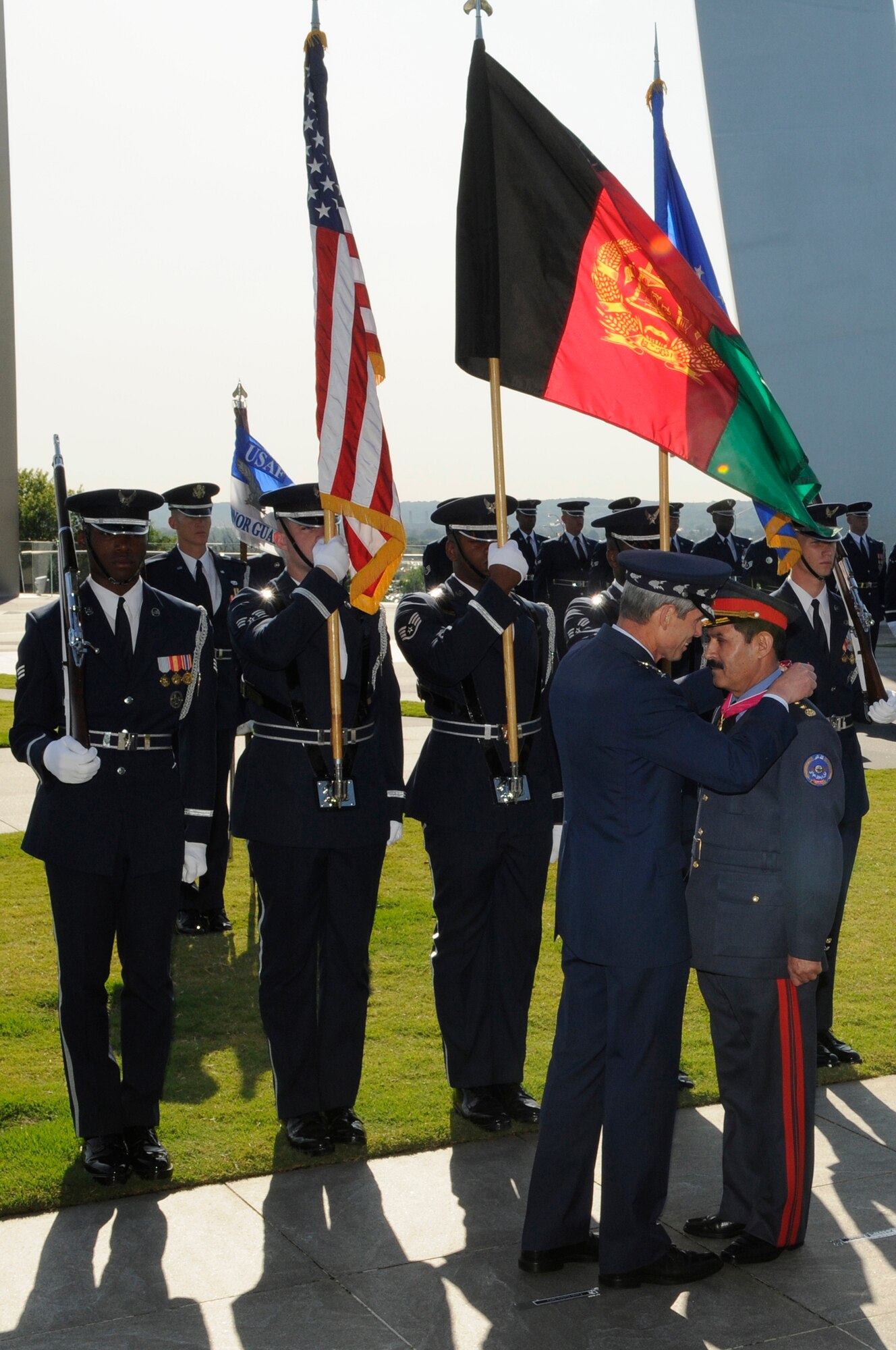 Gen. Norton Schwartz, Air Force chief of staff, presents the Legion of Merit, to Maj. Gen. Mohammad Dawran, commander Afghan National Army Air Corps, during a ceremony July 14 at the Air Force Memorial in Arlington, Va. The Legion of Merit is a military decoration of the United States armed forces that is awarded to foreign government political and military figures for exceptional meritorious conduct in the performance of outstanding services and achievements.  (U.S. Air Force photo by Staff Sgt. Dan DeCook)