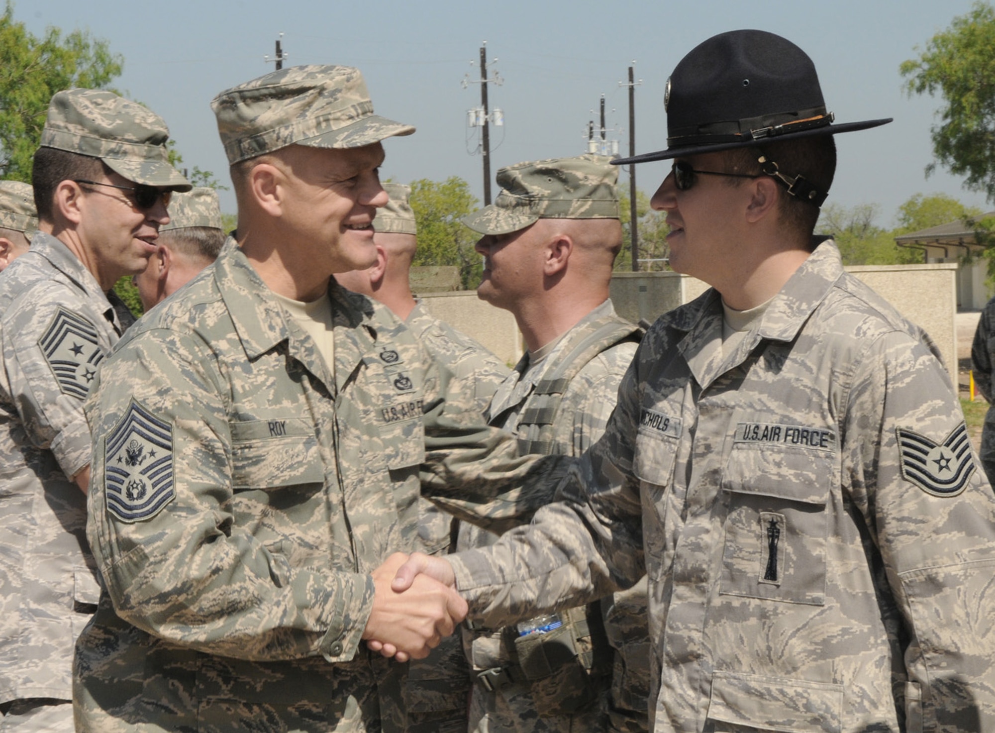 Chief Master Sergeant of the Air Force James A. Roy shakes hands with Tech. Sgt. Chuck Nichols, a 322nd Training Squadron military training instructor, July 9 at Lackland Air Force Base, Texas. (U.S. Air Force photo/Joel Martinez)