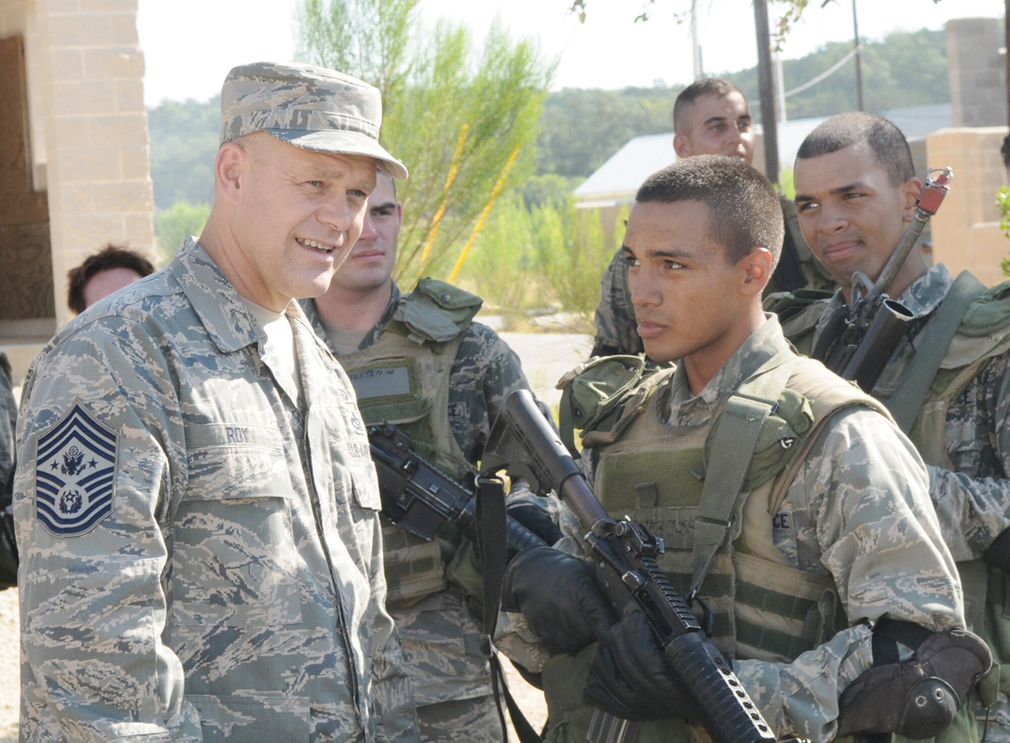 Chief Master Sergeant of the Air Force James A. Roy talks with security forces technical school students during Movement Over Urban Terrain training July 9 at Lackland Air Force Base, Texas. (U.S. Air Force photo/Joel Martinez)