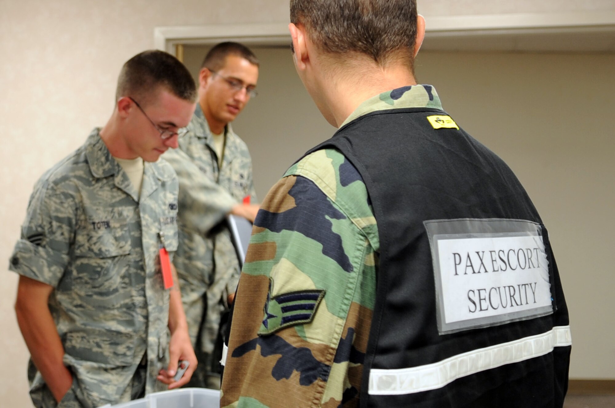 BARKSDALE AIR FORCE BASE, La. -- Airmen working as pax escort security perform a 100 percent hand-carried luggage check and escorts deplorers to the restroom. Currently there are approximately 230 personnel assigned to the READY team, due to current operation tempo, in order to maintain required augmentees on station to fill requirements.  (U.S. photo/ Airman 1st Class Brittany Y. Bateman)