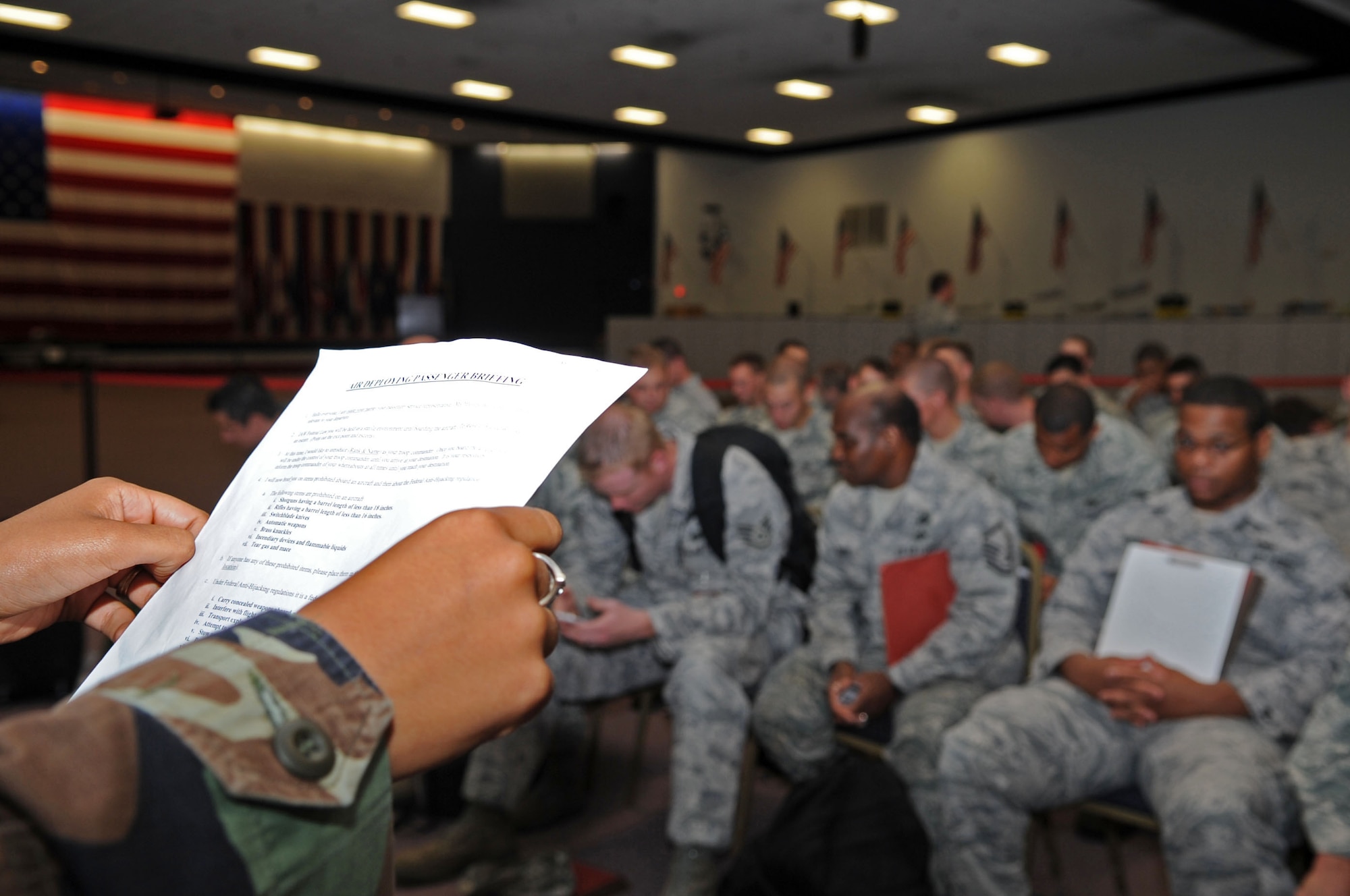BARKSDALE AIR FORCE BASE, La. -- Senior Airman Janisse Morris, 2d Dental Squadron, performs an air deploying passenger briefing. Airman Morris is a part of the resource augmentation duty team. (U.S. photo/ Airman 1st Class Brittany Y. Bateman)(RELEASED)