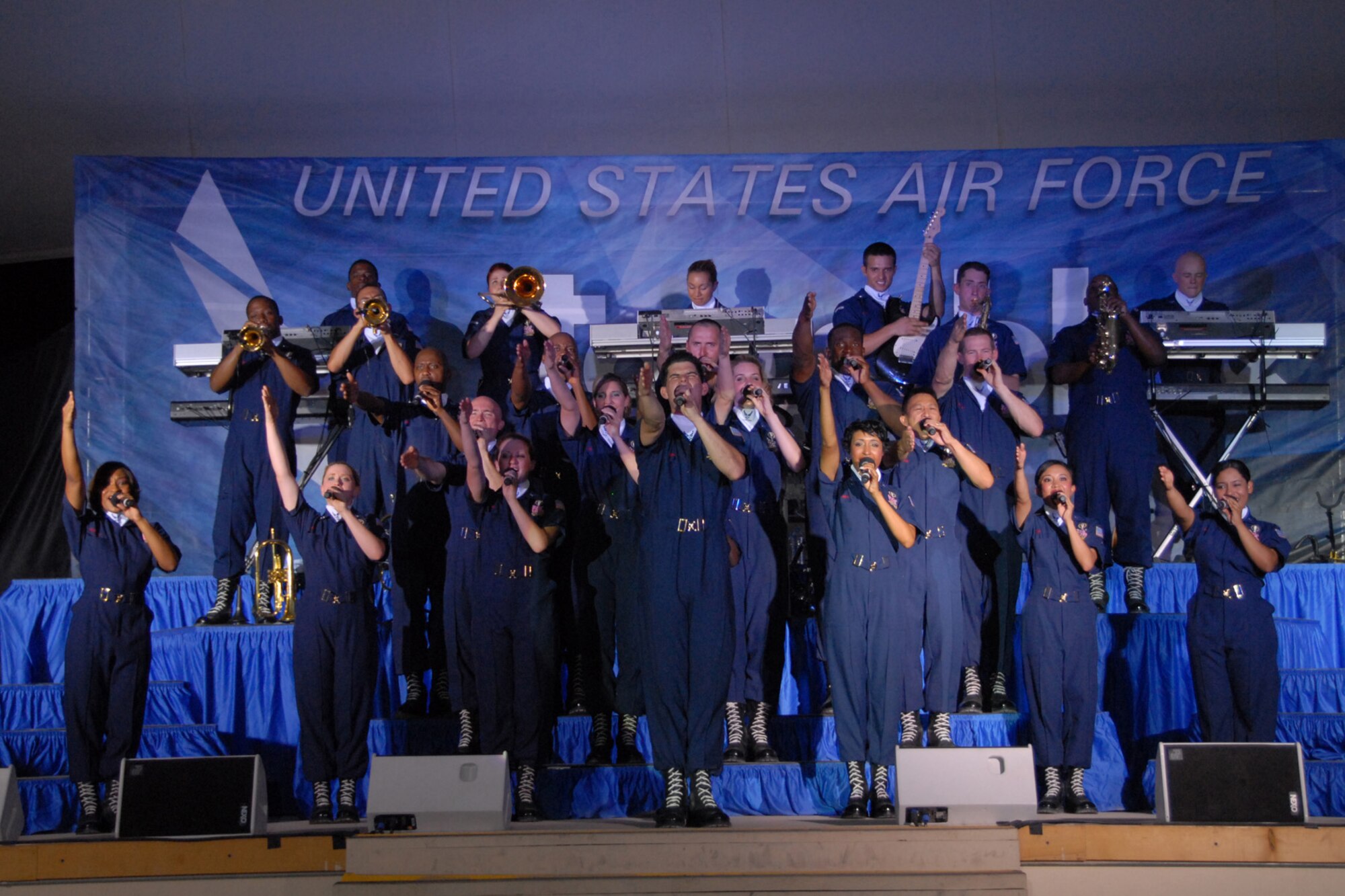 Members of Tops In Blue, the Air Force's premier entertainment group, sing during a performance in Southwest Asia on July 14. The group performed a myriad of songs for the more than 300 base personnel in attendance. (US Air Force photo/Tech. Sgt. Jason Edwards)