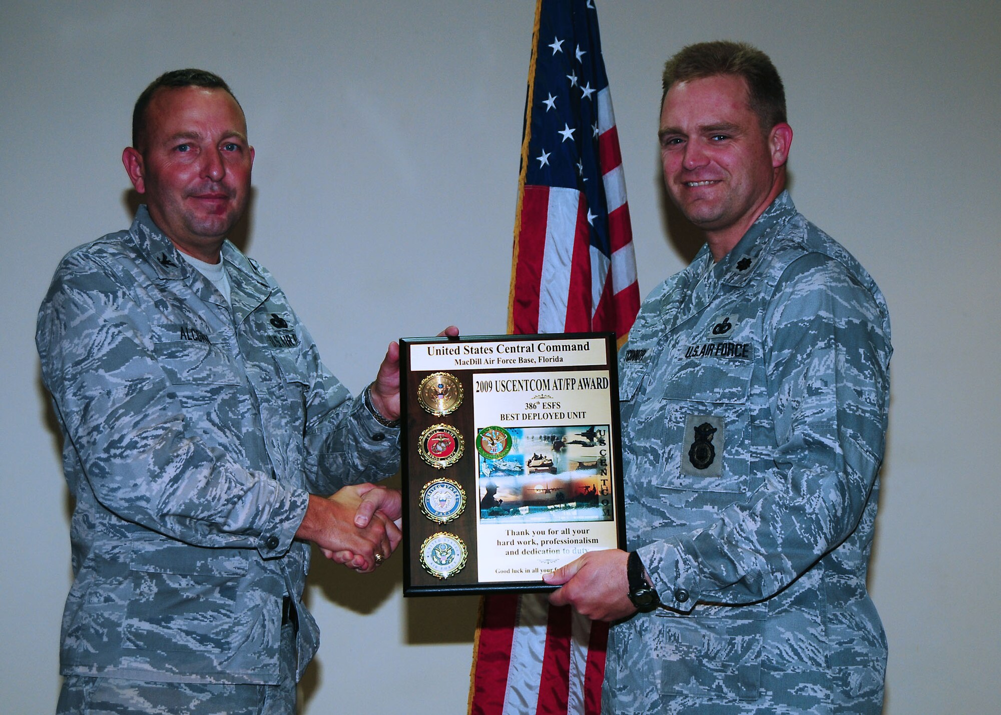 Lt. Col. Jack O' Connor, right, 386th Expeditionary Security Forces Squadron commander, accepts the 2009 CENTCOM Antiterrorism/Force protection Award for best deployed unit from Col. David Alcorn, Headquarters Central Command JSO deputy director, during an awards presentation held at an undisclosed location in Southwest Asia July 14.  The 386th ESFS have won this award for the last four years.  The award was established to recognize personal and organizational efforts aimed at protecting Department of Defense personnel and installations.  (U.S. Air Force photo/Tech Sgt. Tony Tolley)