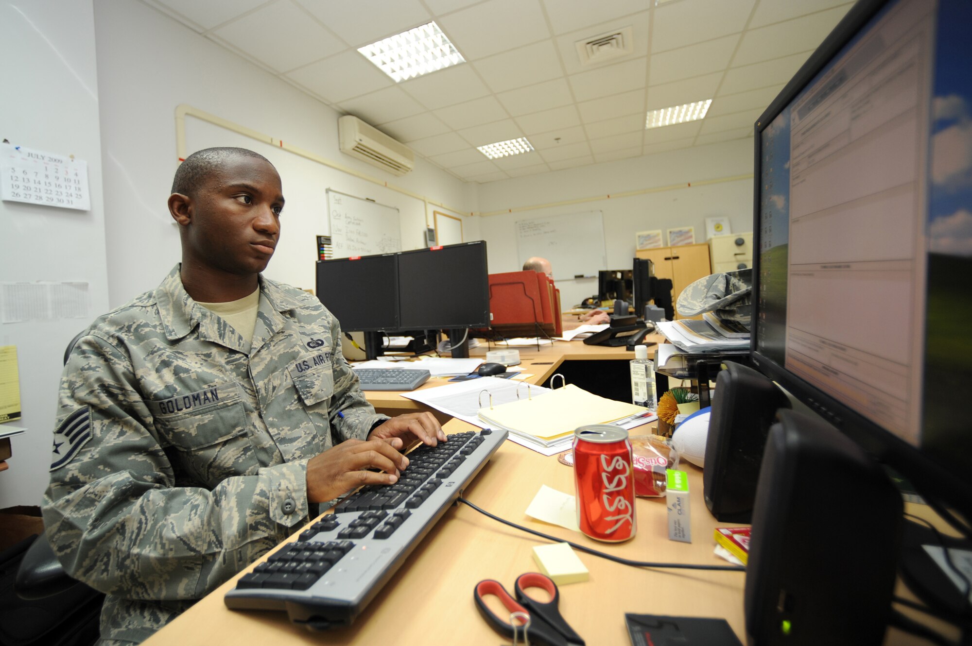 SOUTHWEST ASIA - Staff Sergeant Kevin Goldman, 380th Expeditionary Communications Squadron, fills out an Air Force Form 9 used to request items for purchase July 13. Sergeant Goldman is currently working as a requirements manager, and hails from Colorado Springs, Colo. (U.S. Air Force photo by Tech. Sergeant Charles Larkin Sr) 