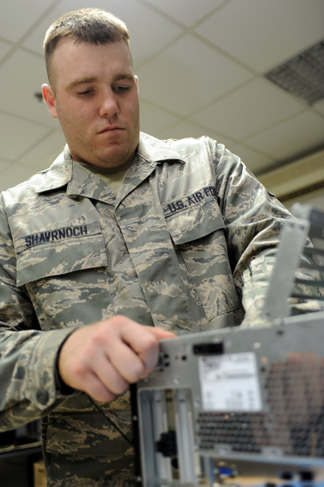 SOUTHWEST ASIA - Airman 1st Class Jared Shavrnoch, 380th Expeditionary Communications Squadron, replaces circuit cards in a desktop computer July 13. Airman Shavrnoch is currently working as a small computer technician, and hails from Millington, Mich. (U.S. Air Force photo by Tech. Sergeant Charles Larkin Sr) 