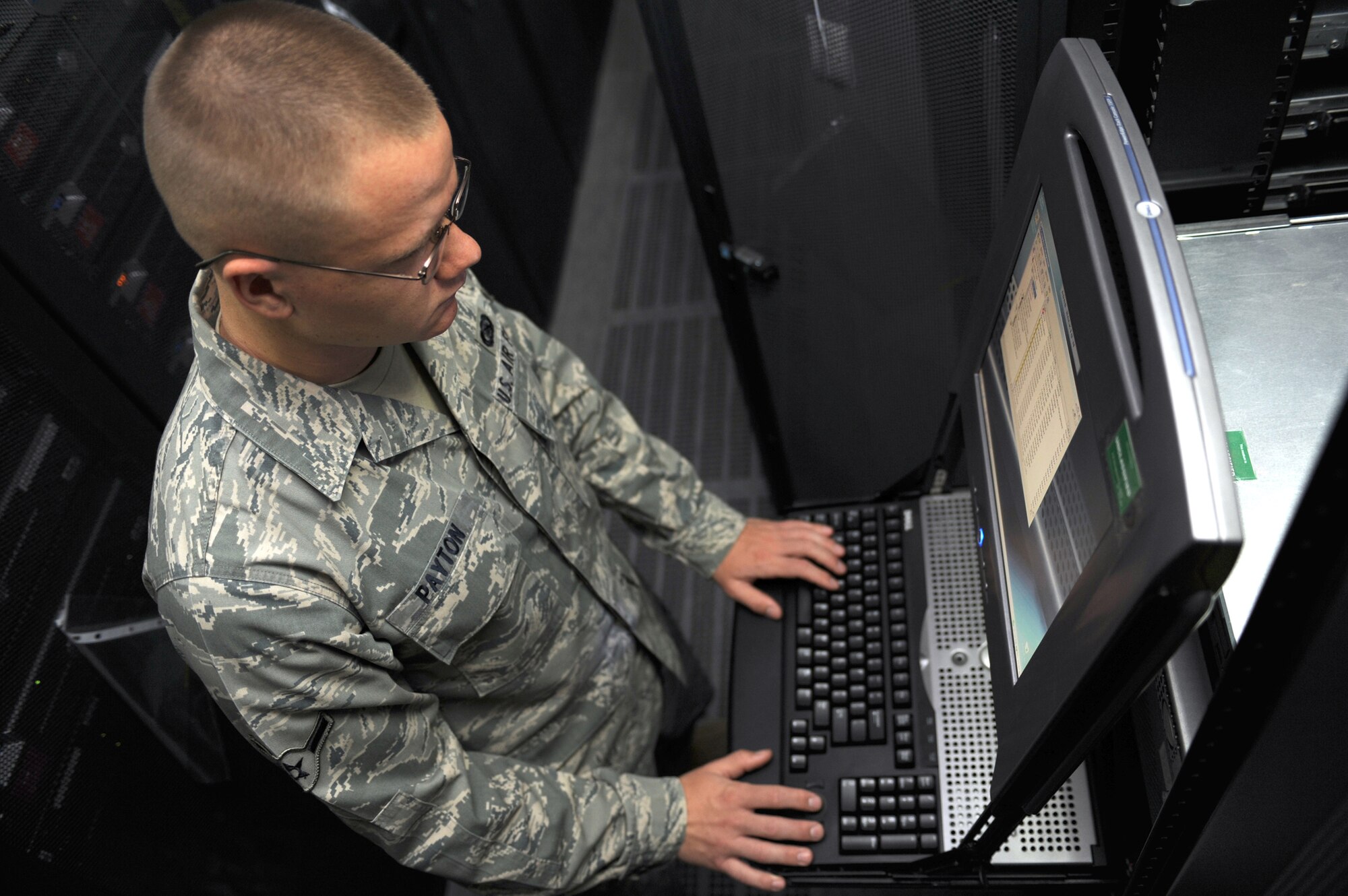 SOUTHWEST ASIA - Airman Bryan Payton, 380th Expeditionary Communications Squadron, completes an operational check on a portion of the base network July 13. Airman Payton is currently working as a Network systems administrator, and hails from Minonk, Ill. (U.S. Air Force photo by Tech. Sergeant Charles Larkin Sr) 