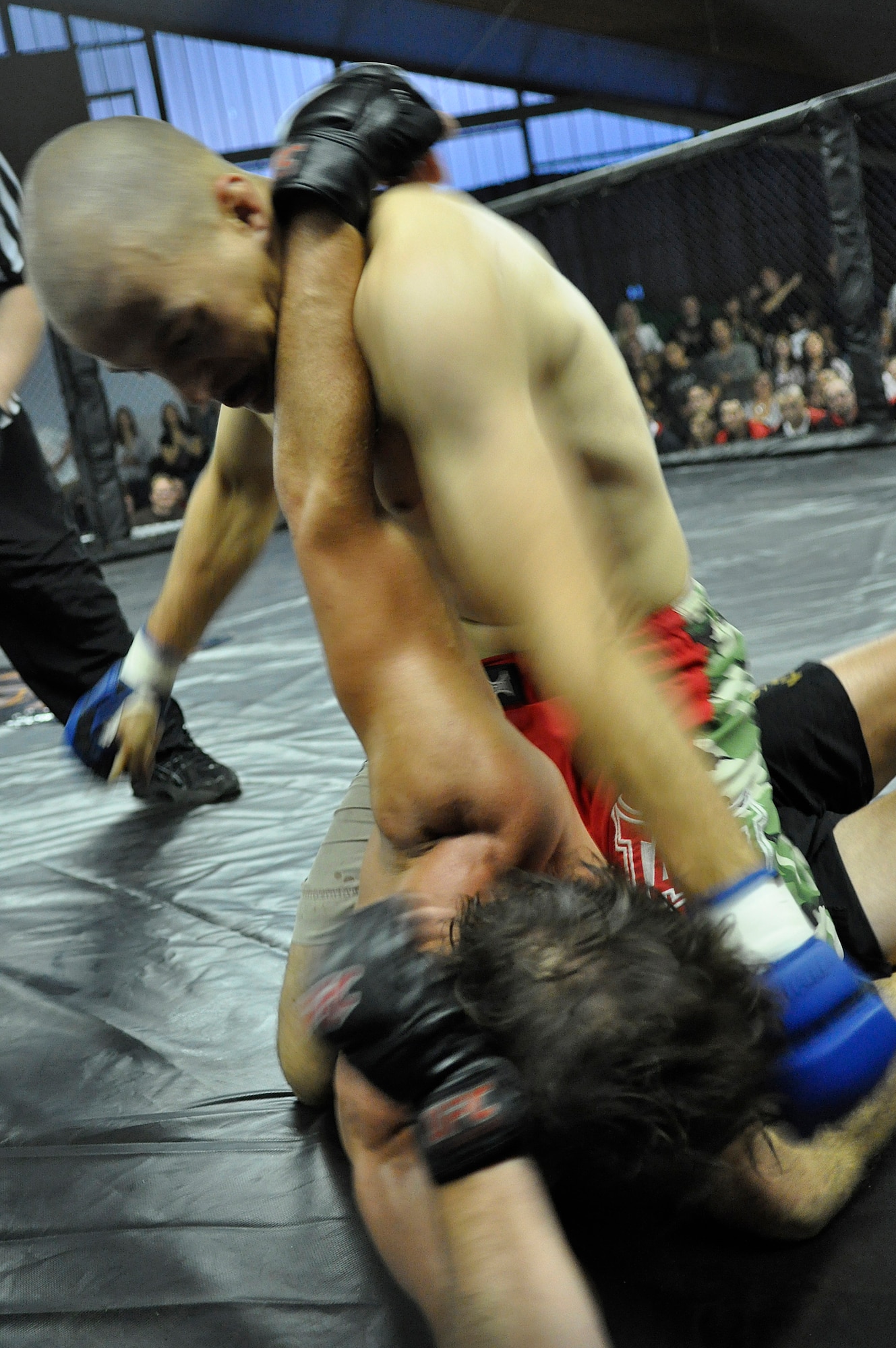 U.S. Air Force Staff Sgt. Anthony Durnell, 786th Security Forces Squadron Regional Training Center instructor, pummels Cedric “Crazy Eyes” Jouvet of France to win the God’s of War Lightweight Championship Belt July 11, 2009, Baumholder, Germany. (U.S. Air Force photo by Staff Sgt. Stephen J. Otero)