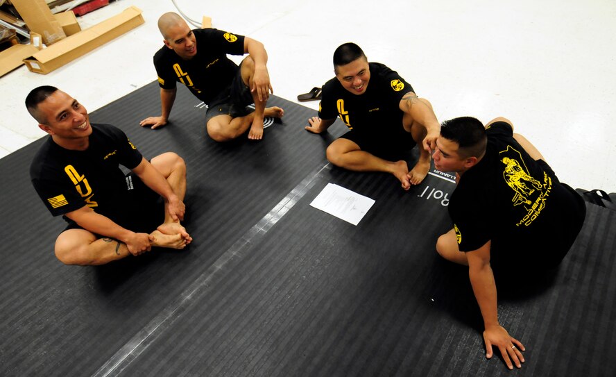 ANDERSEN AIR FORCE BASE, Guam - Modern Army Combative Training instructors take time out to discuss techniques the Soldiers and Airmen used during their grappling matches here June 9.The program is designed to teach Soldiers and Airmen how to fight hand-to-hand when weapons use is not practical in a combat situation. (U.S. Air Force photo by Airman 1st Class Courtney Witt)