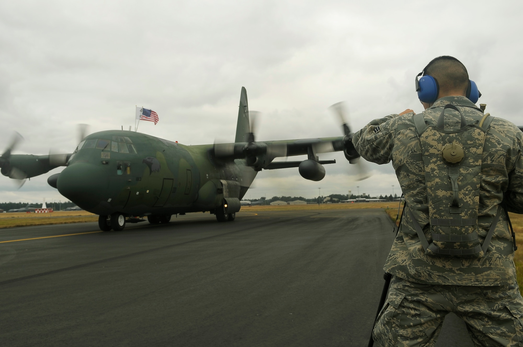 Senior Airman Jonathan Garcia, 4th Combat Camera, documents the arrival of a Republic of Korea C-130 aircraft at McChord July 13, 2009. The plane and its crew have come to compete in Air Mobility Command's Rodeo 2009, an international competition that focuses on improving worldwide air mobility forces' professional core abilities. (U.S. Air Force photo/Senior Airman Dayton Mitchell) 