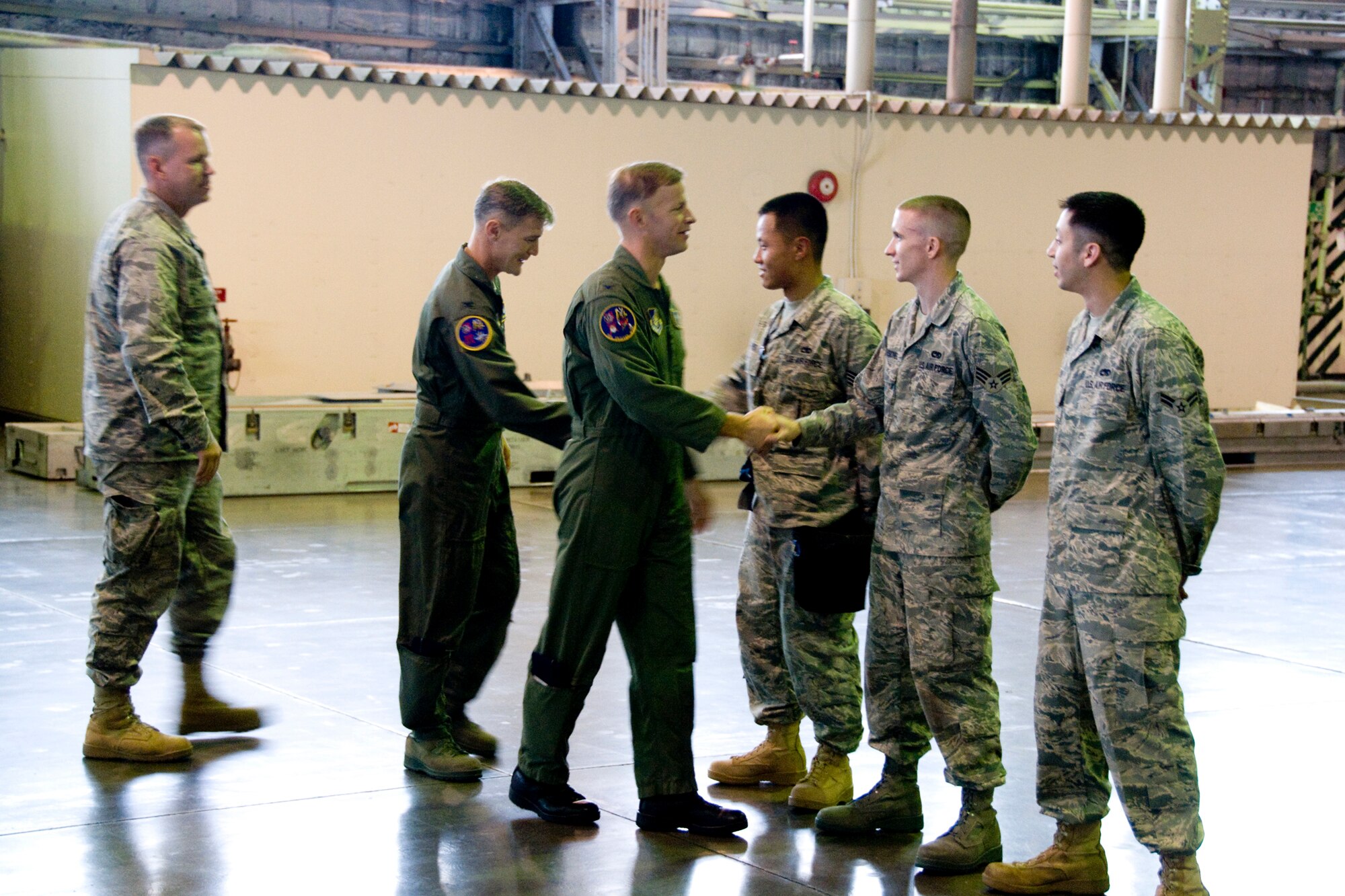 MISAWA AIR BASE, Japan -- Col. RC Craig, 35th Fighter Wing vice commander, and Col. John Pearse, 35th Operations Group commander, congratulate Staff Sgt. David Hsu, Senior Airman Jessie Leuschel and Airman 1st Class Noe Leon after completion of a weapons-load crew competition July 10. The team finished with a time of 26:43 and will be judged against the time of a load crew downrange. (U.S. Air Force photo/Senior Airman Jamal D. Sutter)