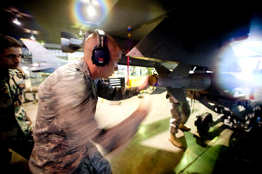 MISAWA AIR BASE, Japan -- Senior Airman Jessie Leuschel, 14th Aircraft Maintenance Unit load crew member, races against the clock during a weapons-load competition July 10. The team's time will be judged against that of a 13th Aircraft Maintenance Unit load crew downrange. (U.S. Air Force photo/Senior Airman Jamal D. Sutter)