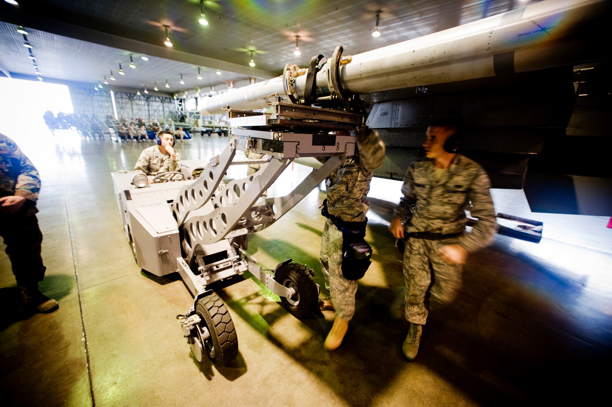 MISAWA AIR BASE, Japan -- Members of a 14th Aircraft Maintenance Unit load crew prepare an AIM-120 air-to-air missile for loading during a quarterly competition July 10. Along with the AIM-120, the team also loaded a GBU-38 joint direct attack munition and an AIM-9X air-to-air missile. (U.S. Air Force photo/Senior Airman Jamal D. Sutter)