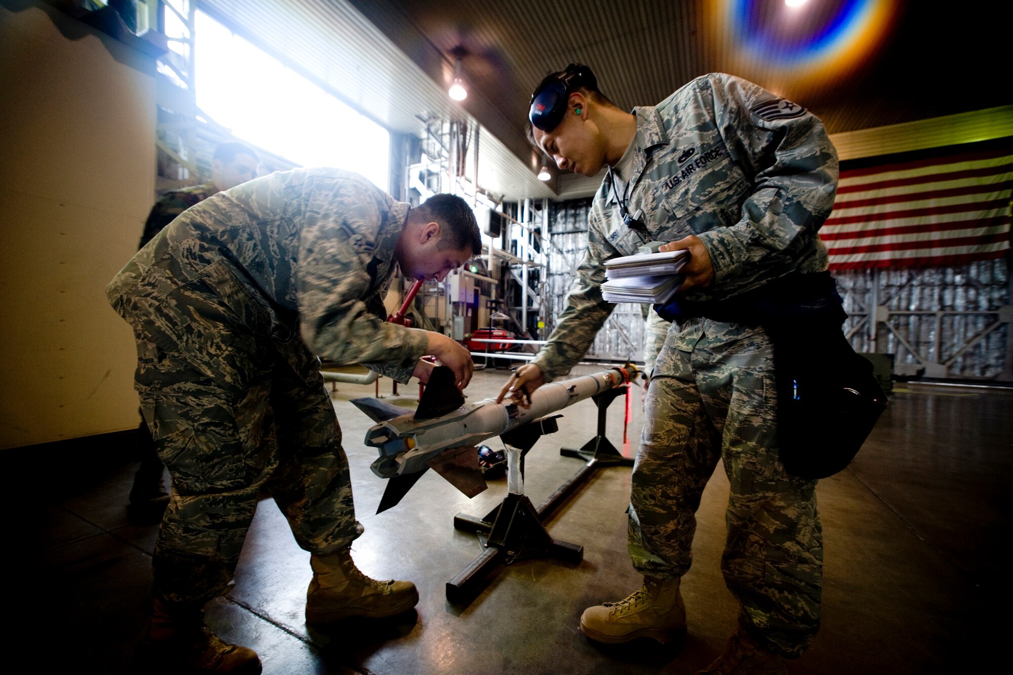 MISAWA AIR BASE, Japan -- Staff Sgt. David Hsu and Airman 1st Class Noe Leon of the 14th Aircraft Maintenance Unit inspect an AIM-9X air-to-air missile during a weapons-load competition July 10. If crowned the best crew of April through June, the team will qualify for the weapons-load crew of the year competition. (U.S. Air Force photo/Senior Airman Jamal D. Sutter)