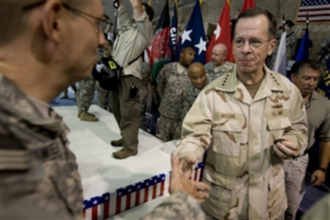 Chairman of the Joint Chiefs of Staff Adm. Mike Mullen, U.S. Navy, greets service members at Bagram Air Base, Afghanistan, on July 14, 2009.  Mullen is accompanying a USO tour featuring Hall of Fame NFL coach Don Shula, NFL running back Warrick Dunn, actors Bradley Cooper and D.B. Sweeney and sports personality and model Leeann Tweeden on a visit to the Central Command area of responsibility.  